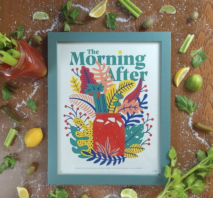 Colorful framed print with the words "The Morning After" above a vibrant illustrated jar filled with various colored leaves and plants, surrounded by celery, lemons, olives, lime, and herbs on a wooden surface.