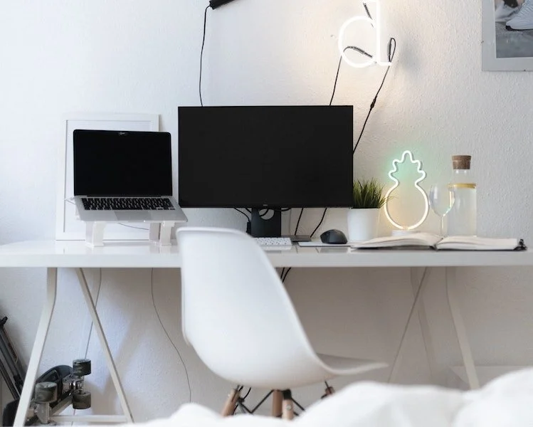 pr pitch follow up email example- laptop and desktop computers on a white desk