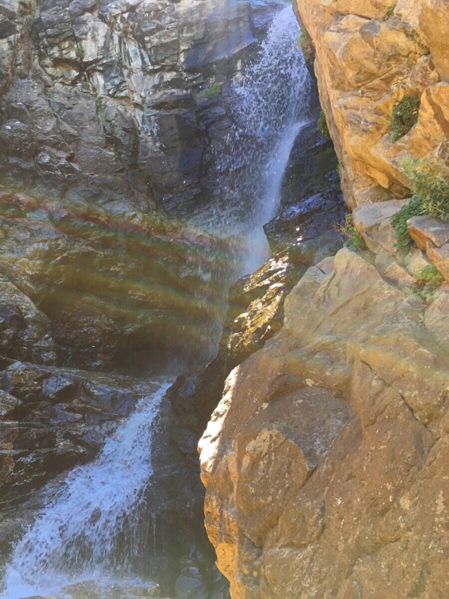 Rocky Mouth near Sandy, Utah - hiking trail to a waterfall with rainbow sunrays