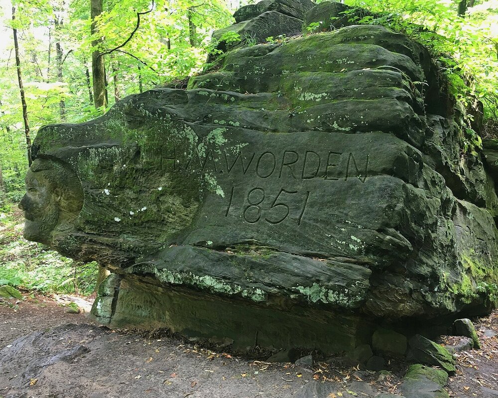 Worden's Ledges hiking trail rock with face and words 'Worden 1851'