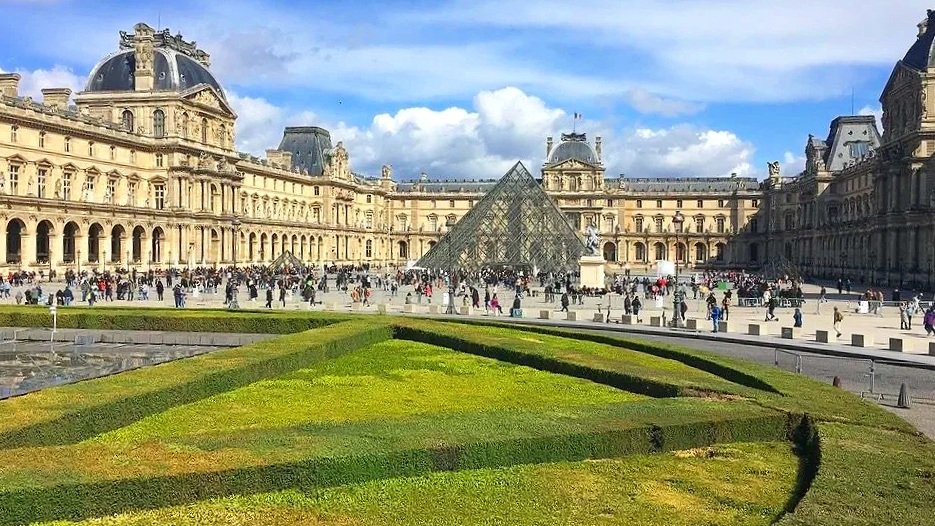 The Louvre Museum, with a pyramid in the center of the courtyard, is a must visit for a first timer in Paris