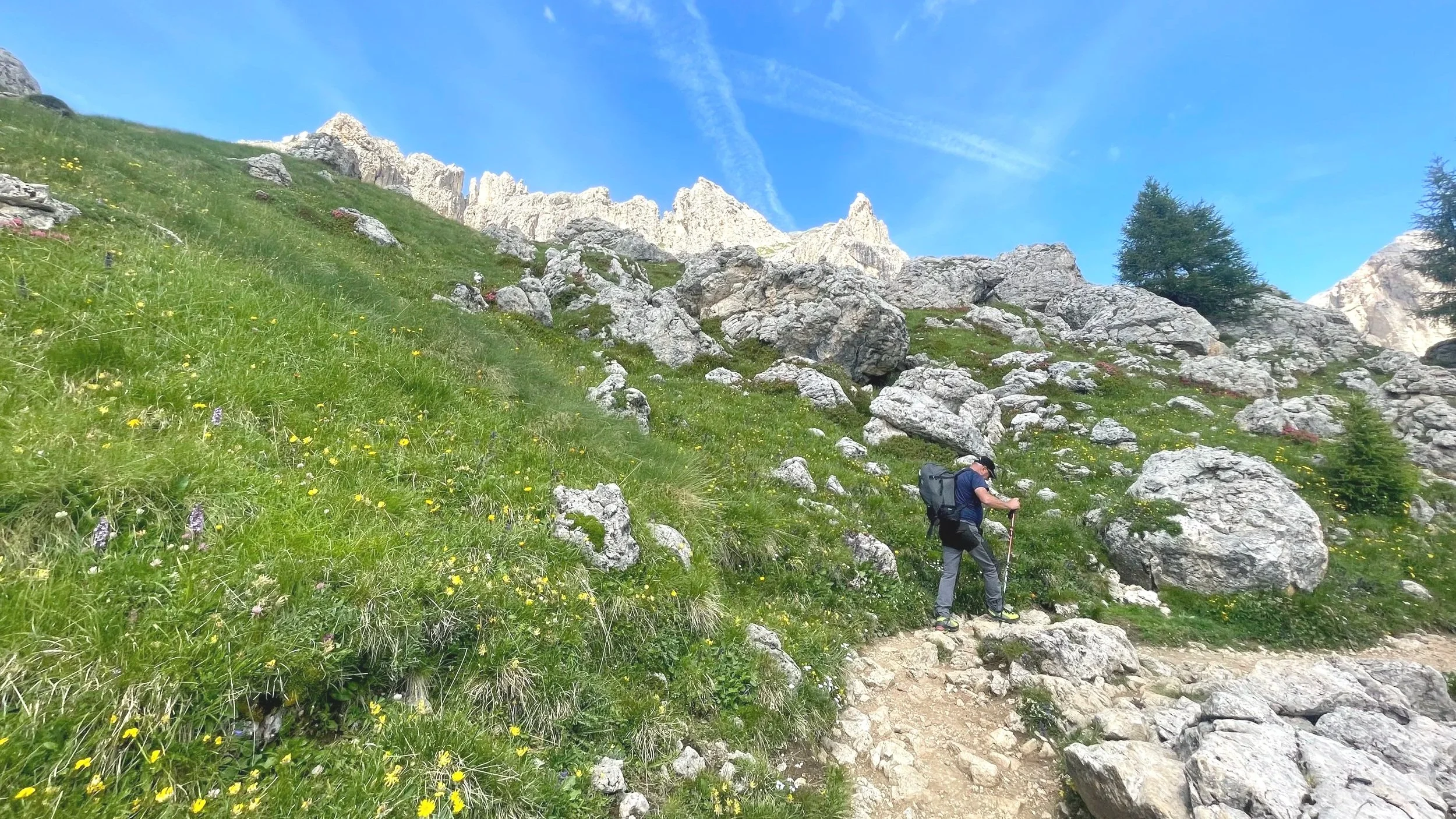 Using trekking poles on a steep hike in Italy's Dolomites
