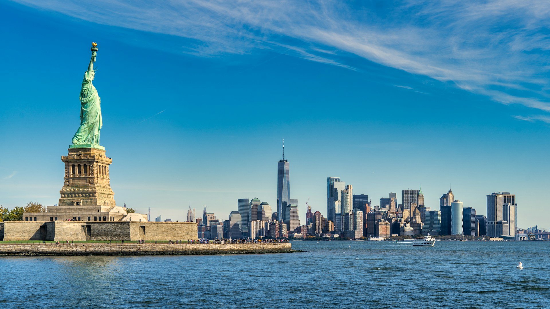 The Statue of Liberty with a backdrop of the NYC skyline