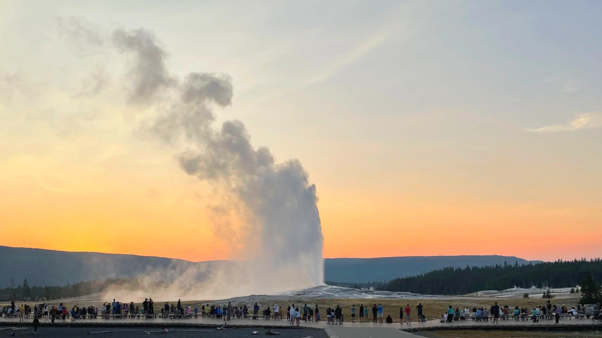 Old Faithful erupts at sunset in Yellowstone National Park