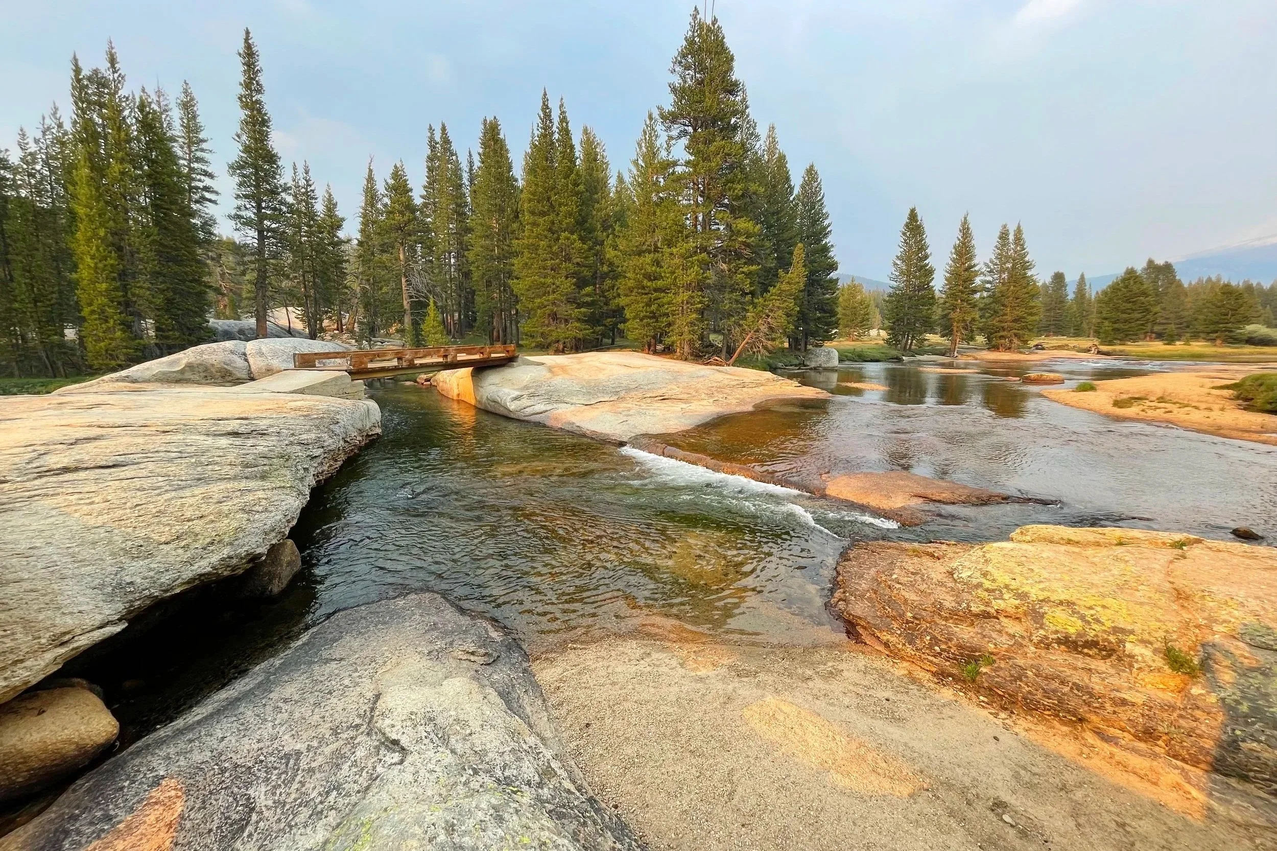 A bridge crosses a river on a trail in Yosemite