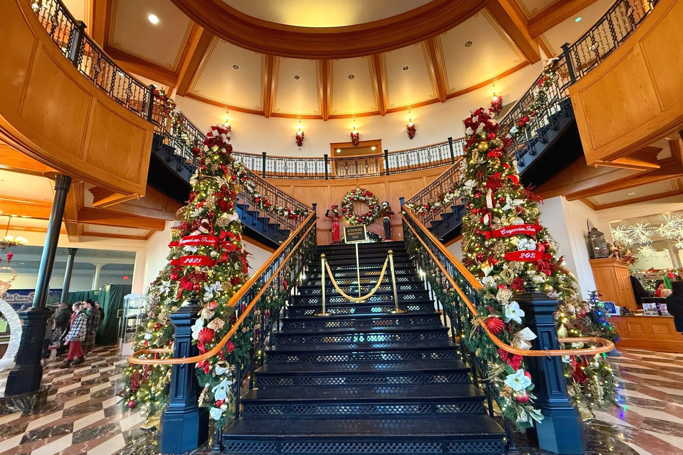 Christmas in Grapevine with decorated Christmas trees inside a grand lobby.