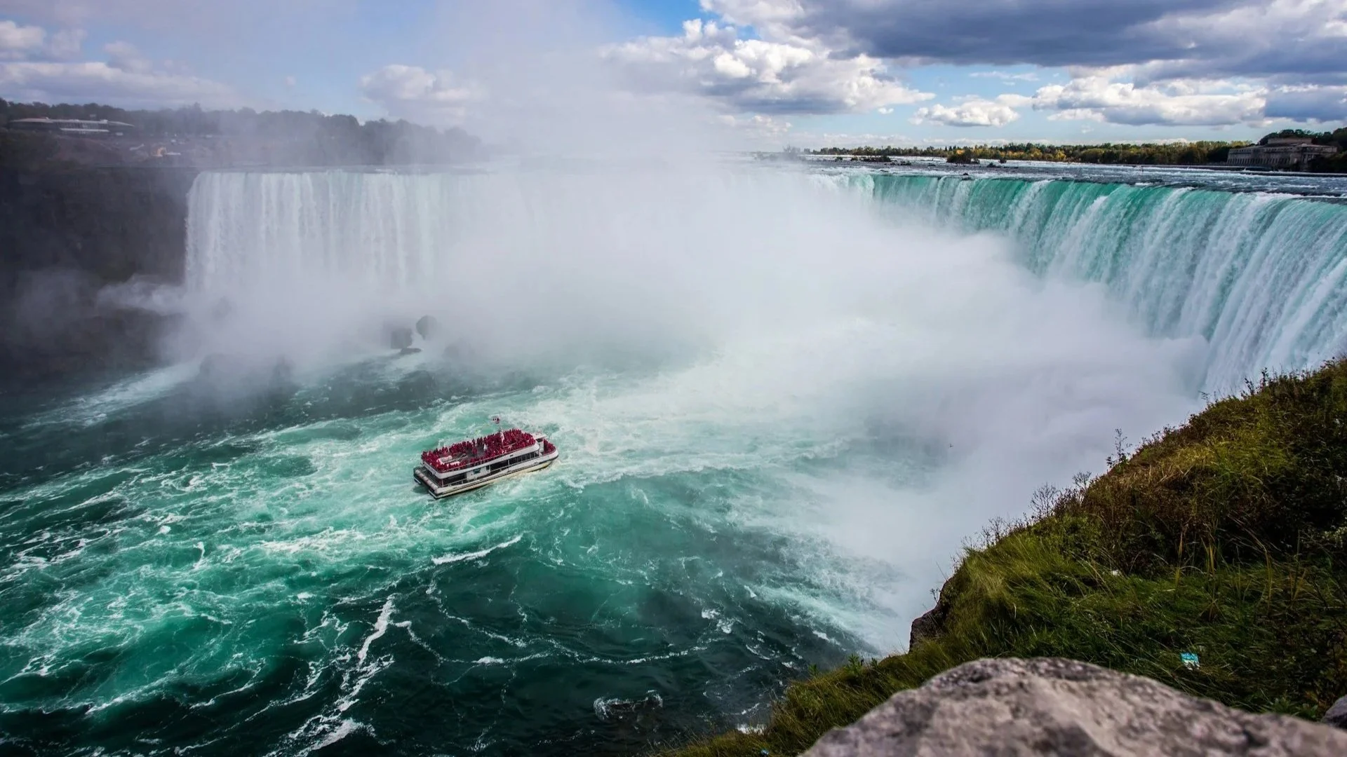 Niagara Falls with a ferry getting close to the falls