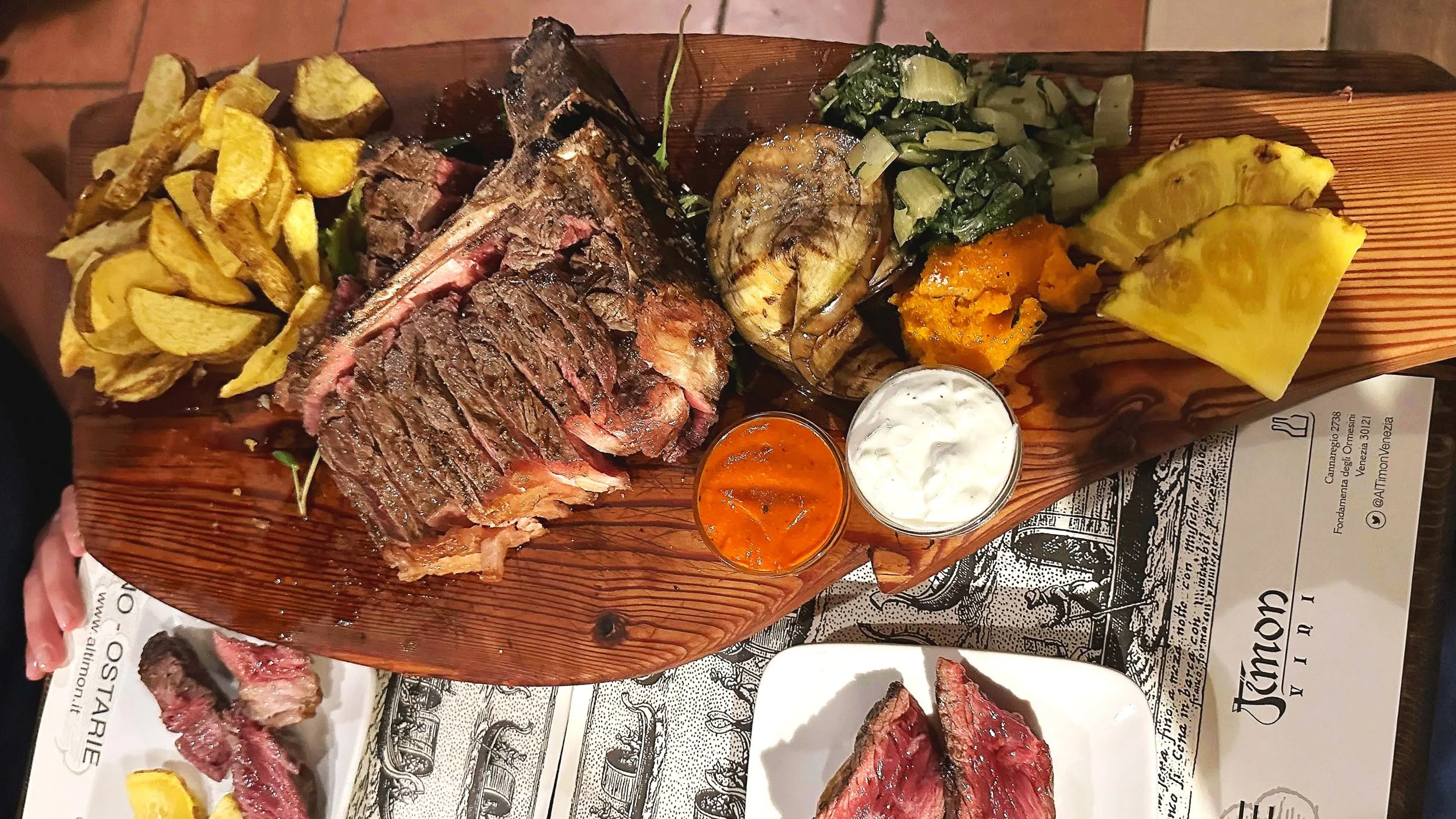 Al Timon serves a platter of steak, sauces, and veggies in Venice.