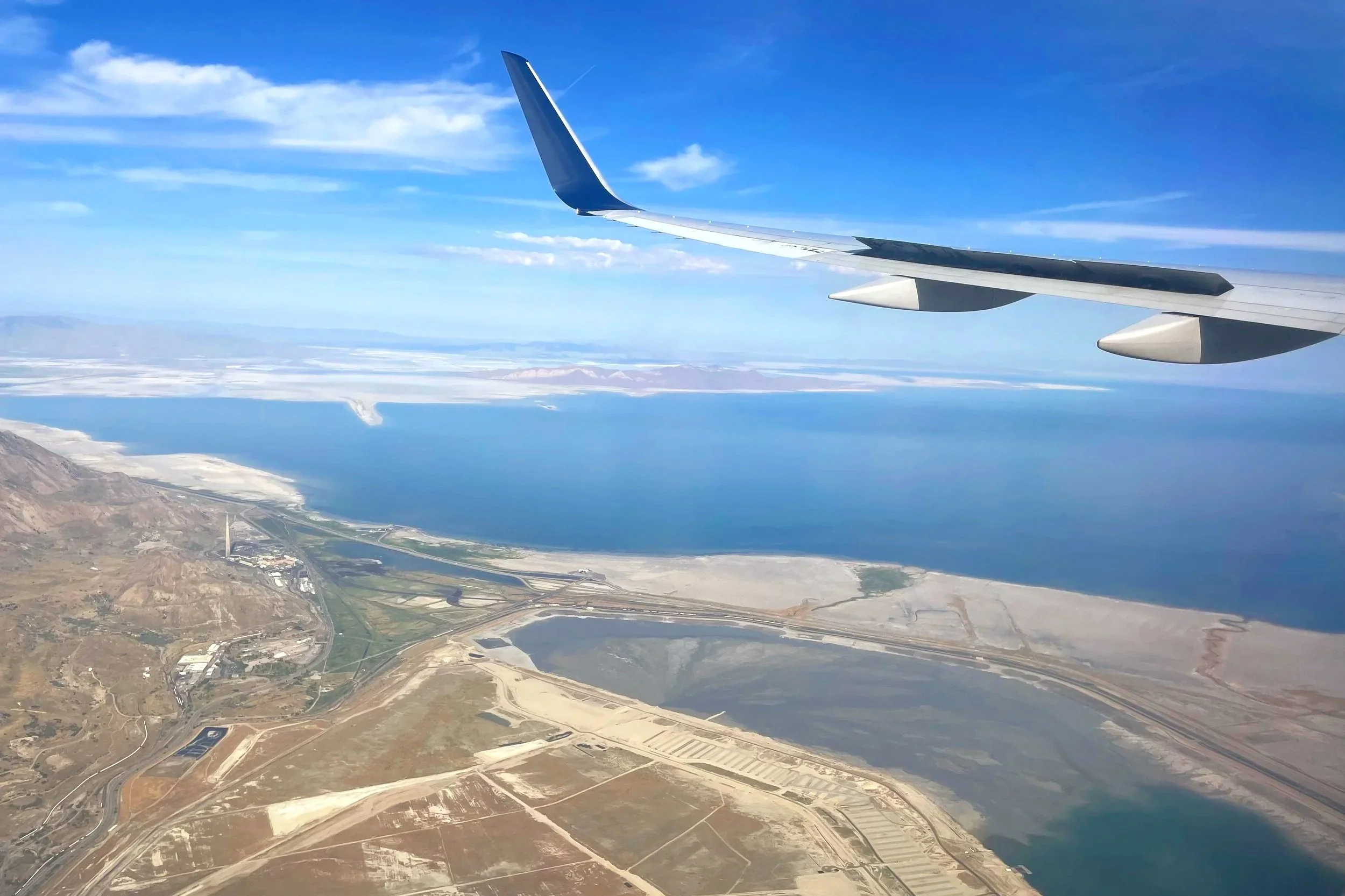 A plane flies over a desert in the US.