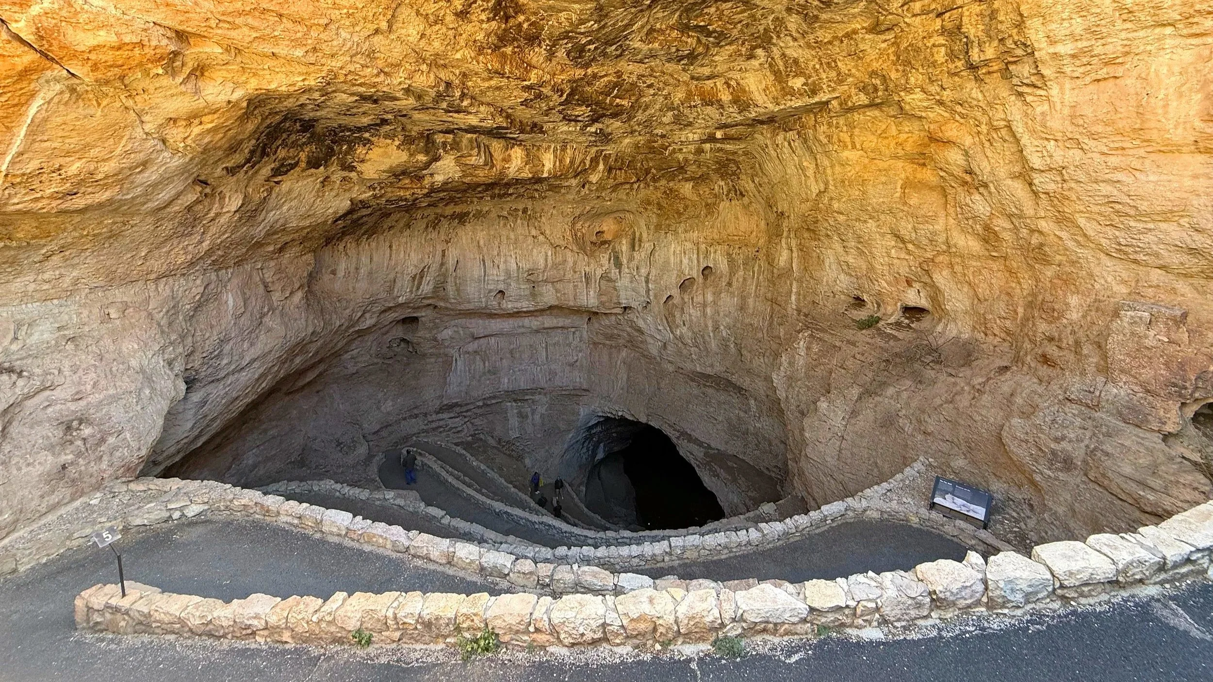 The mouth of Carlsbad Caverns has a winding path down into it.