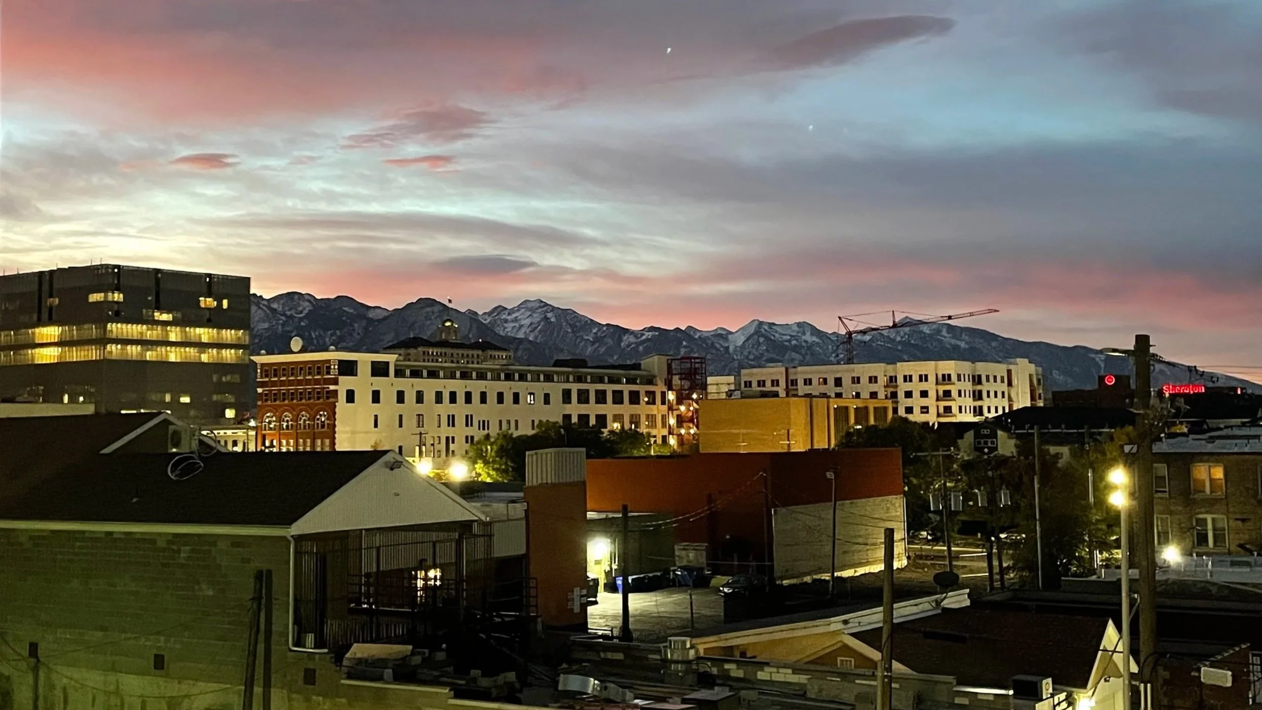 Downtown Salt Lake City skyline at dusk, with a pink sky.