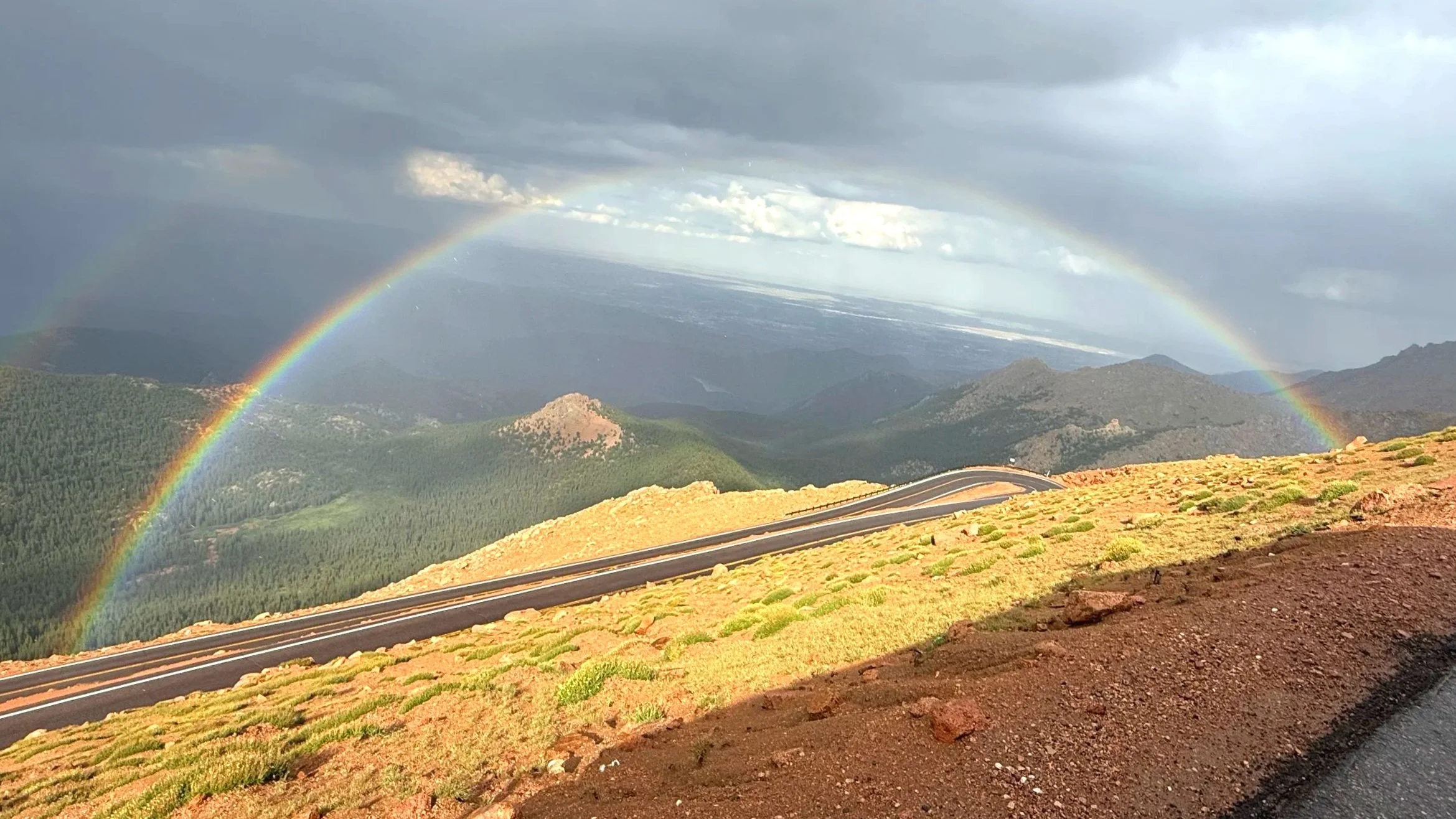 Giant arched double rainbow on the road down from Pike's Peak, Colorado.
