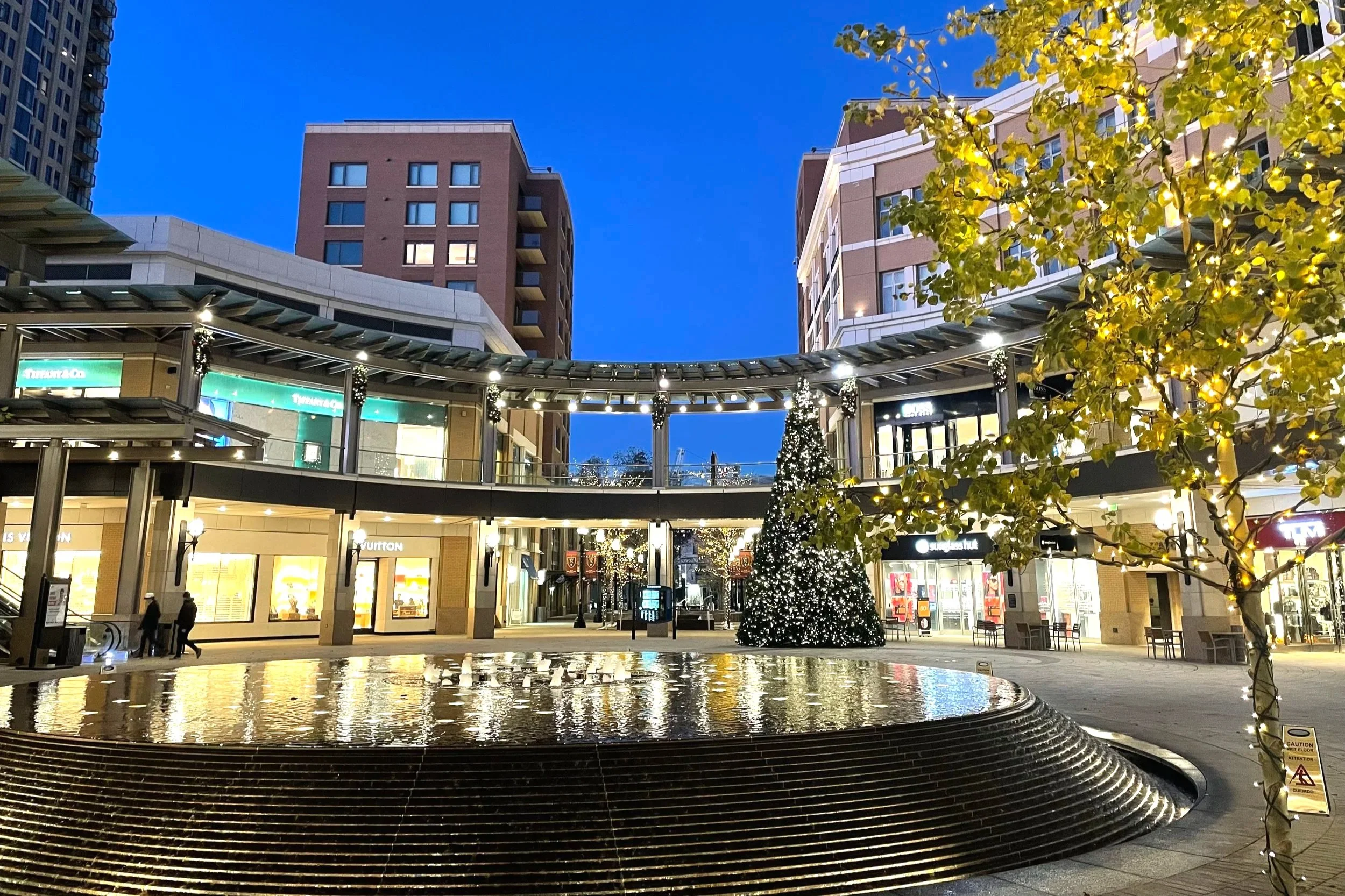 City Creek, an upscale shopping area in Downtown Salt Lake City, lights up at night, with it's fountain reflecting those lights.