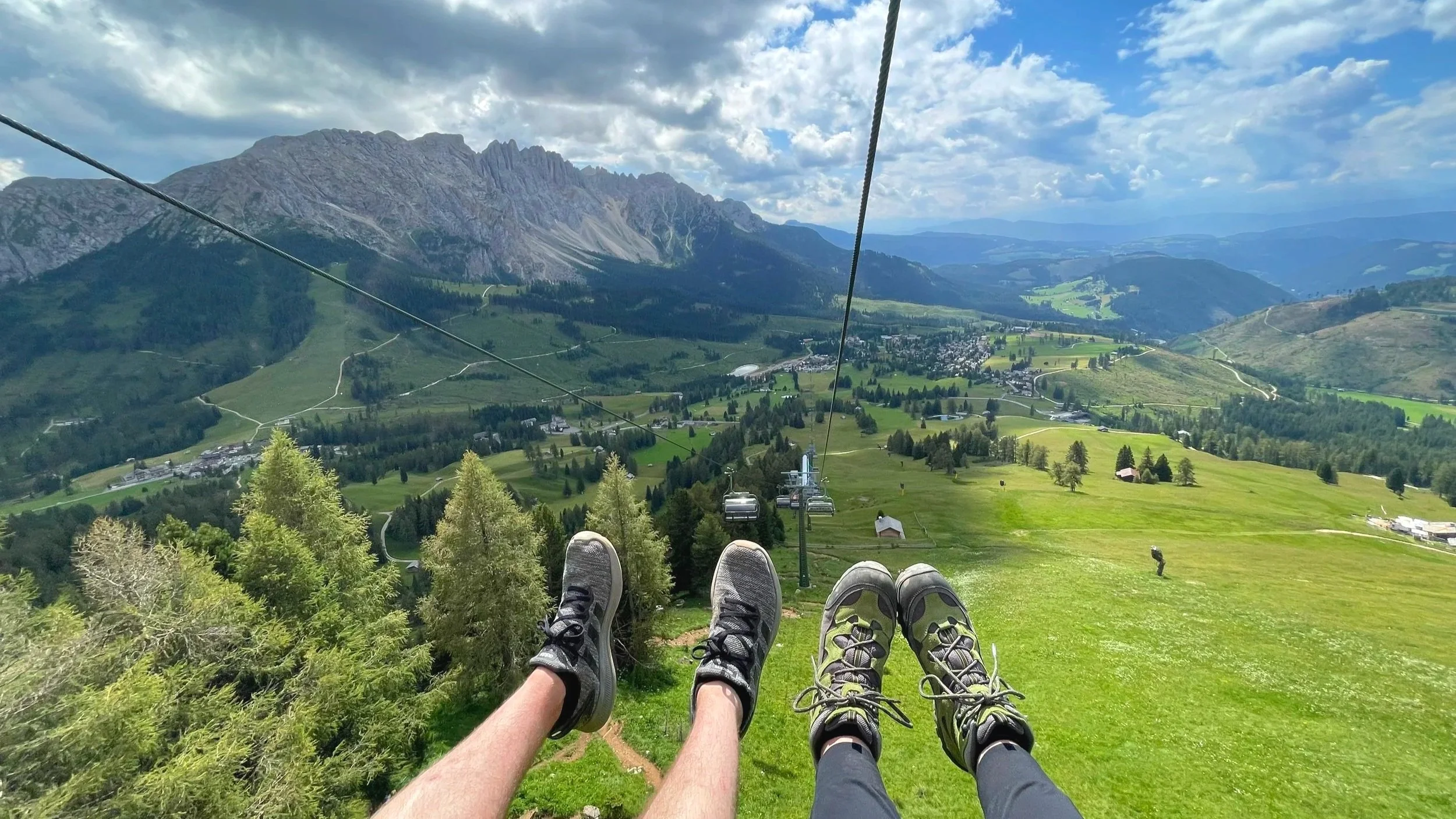 Riding the ski lift with sweeping views of The Dolomites