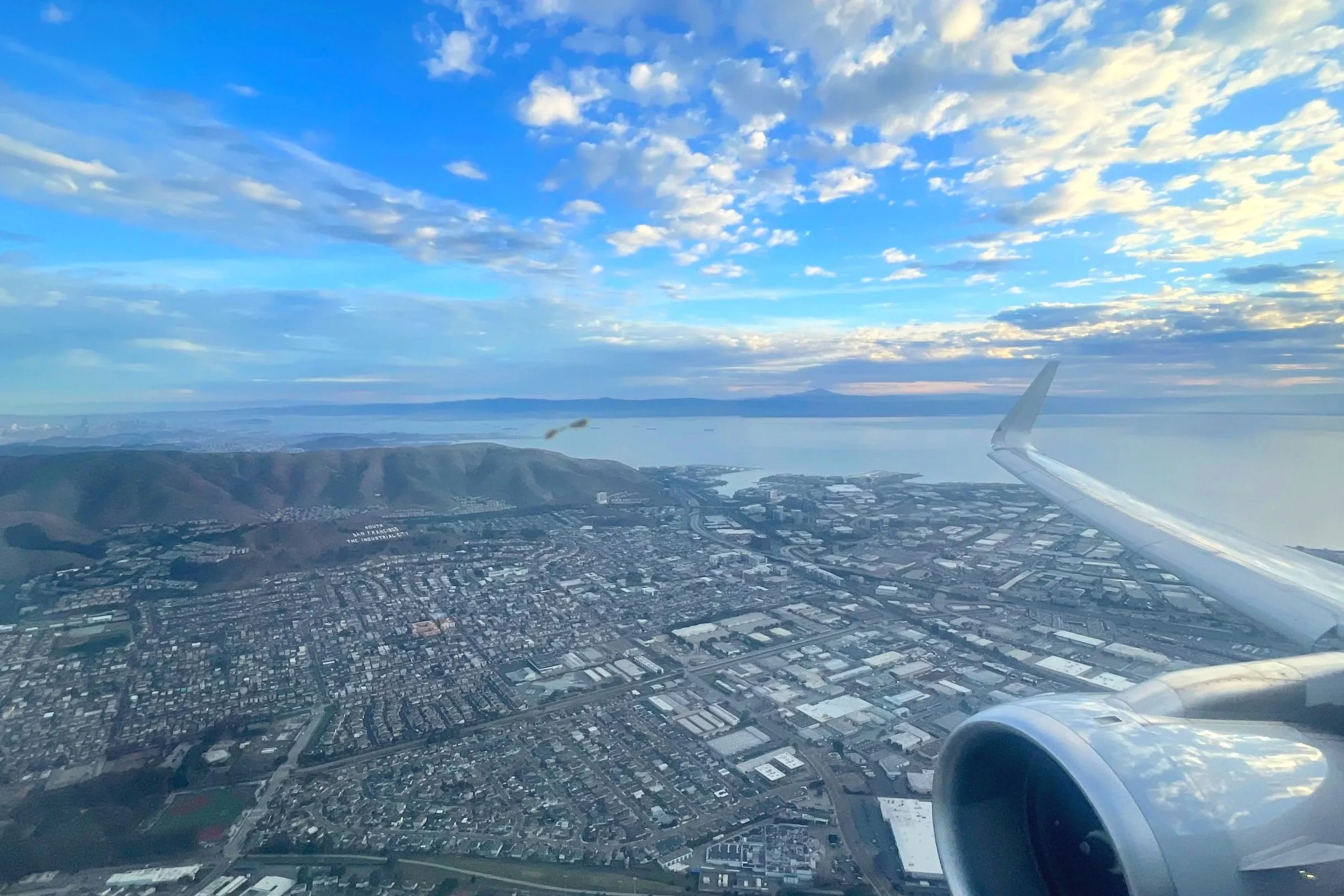 Plane flying over San Francisco and the Pacific Ocean.