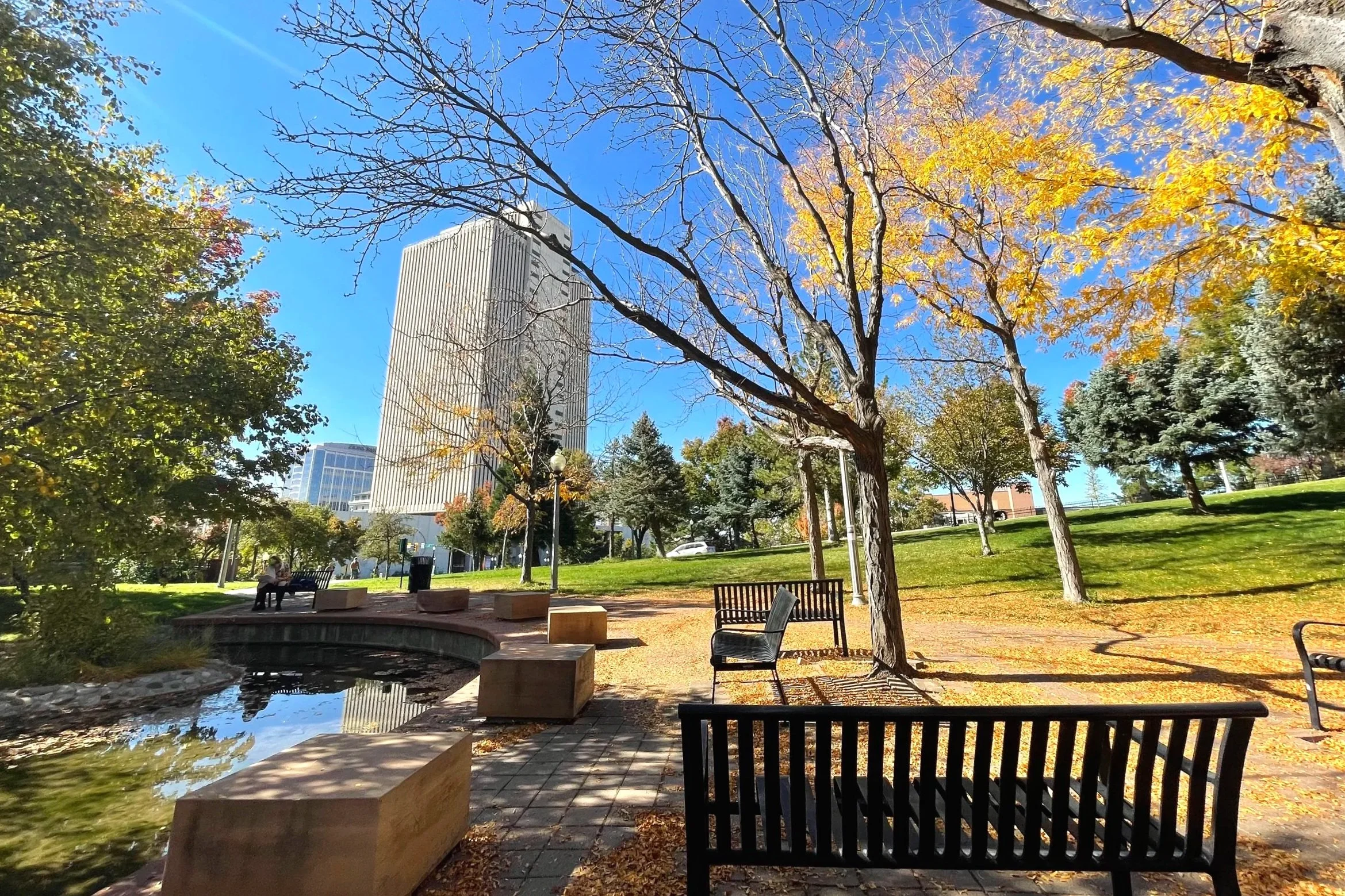 Pretty fall scenery in Downtown Salt Lake City, with a view from a park looking at one of the tallest skyscrapers.