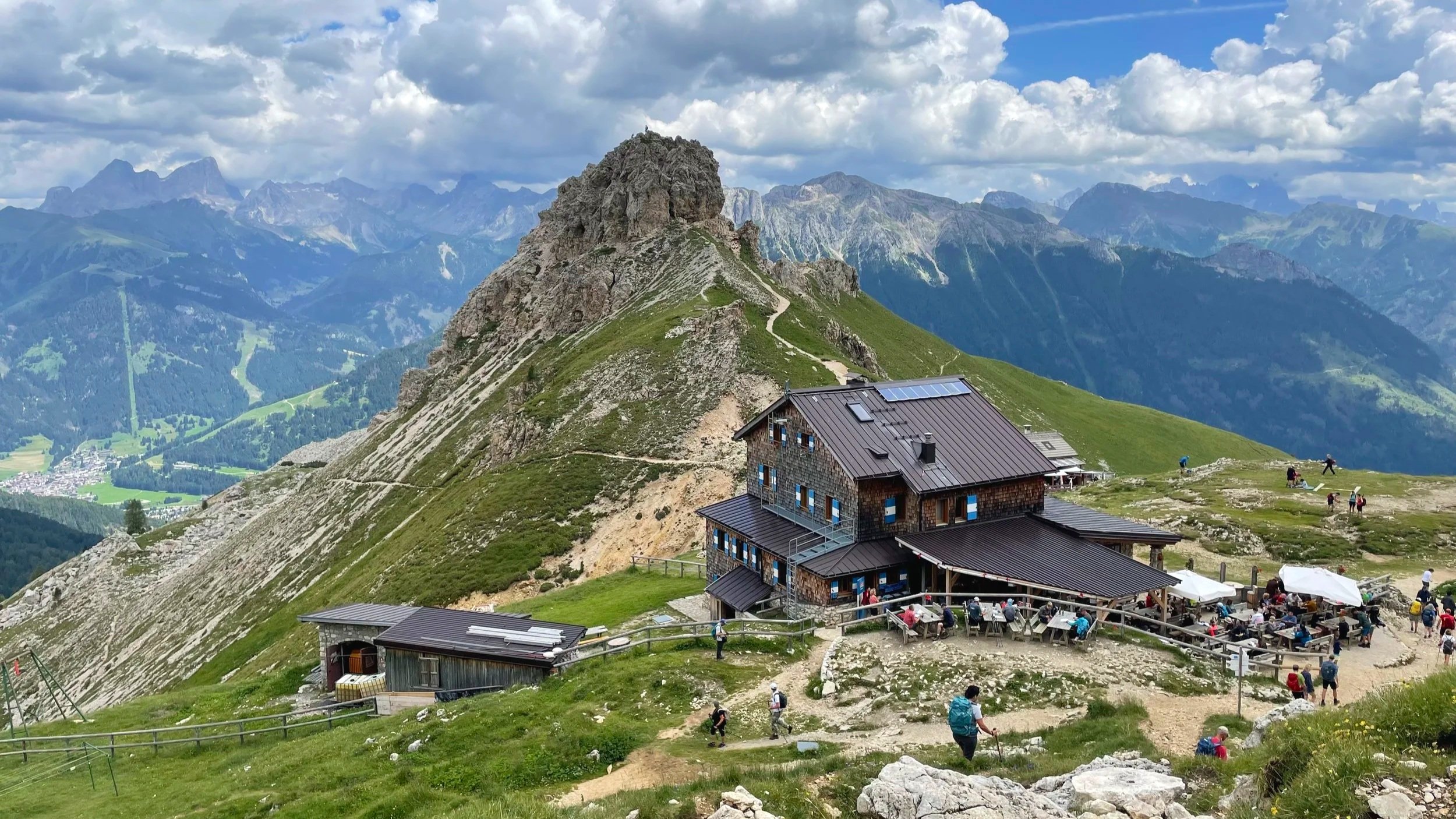 Striking mountain views are seen beyond a lodge in The Dolomites