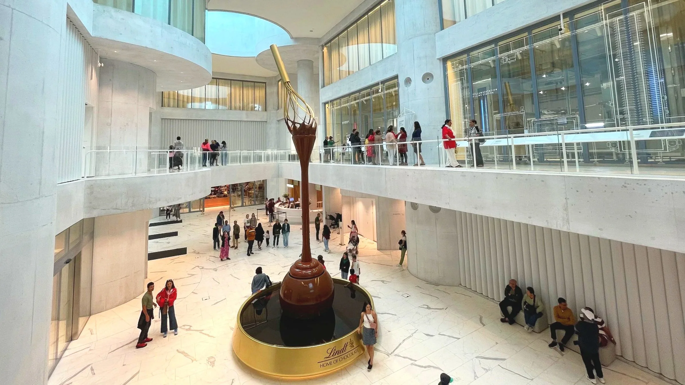 A giant chocolate fountain pours chocolate in the lobby of Lindt Home of Chocolate.