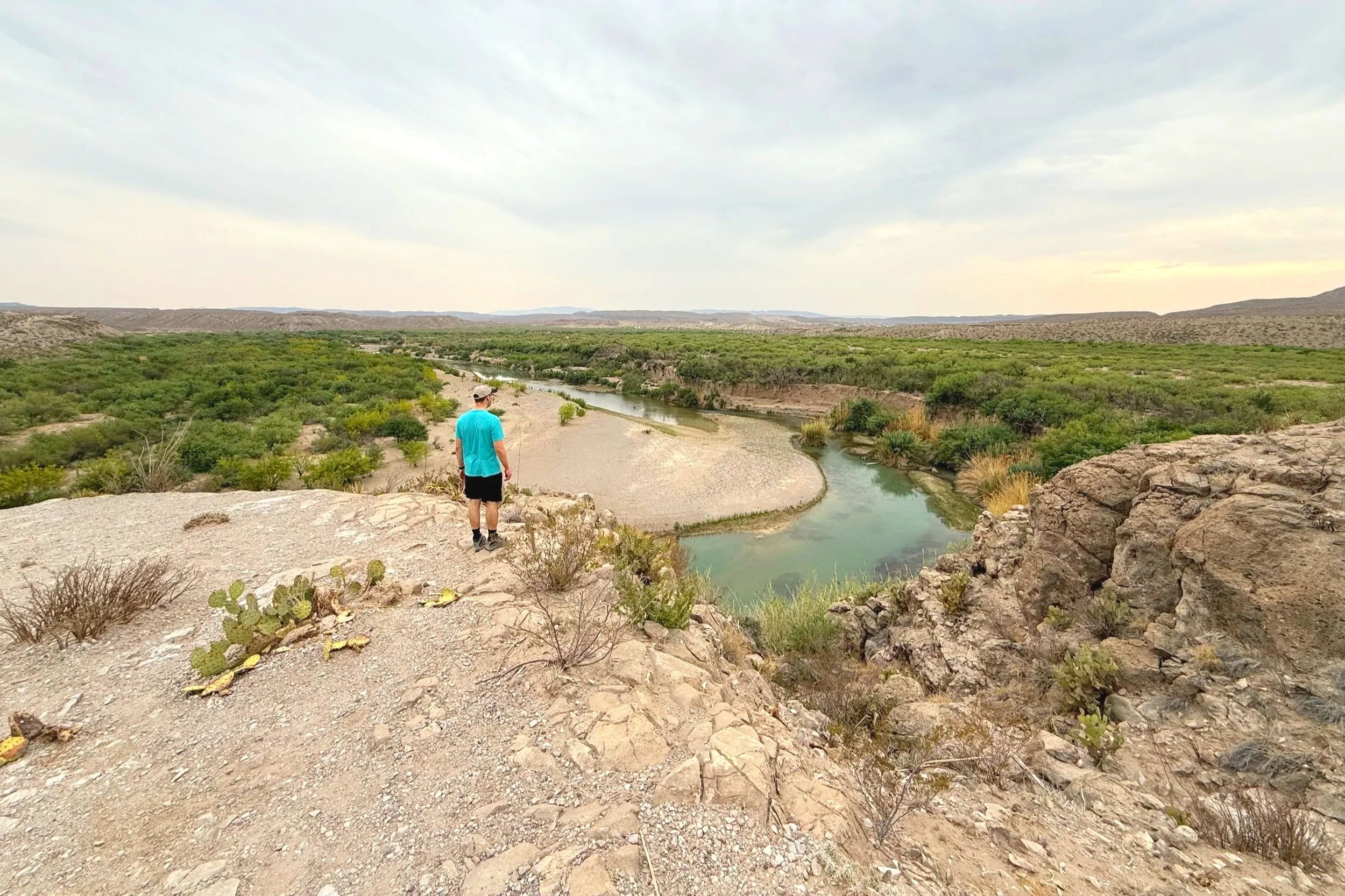 A man stands on an overlook at Big Bend River.