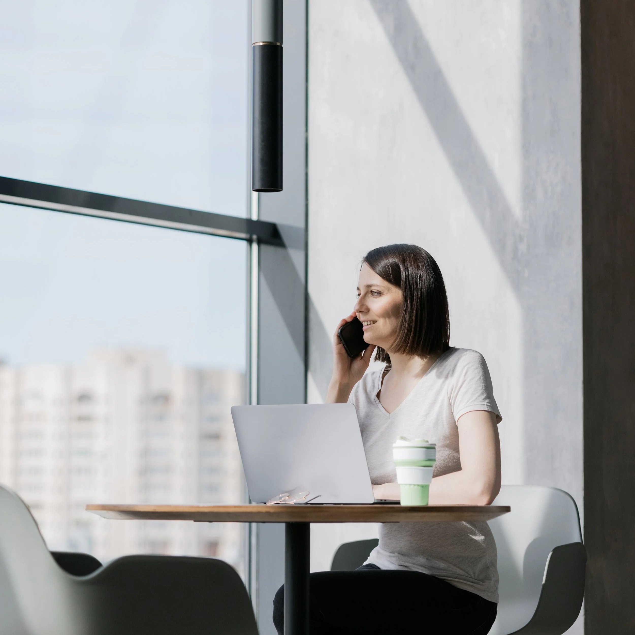 european-business-woman-glasses-drinking-coffee-talking-phone.jpg