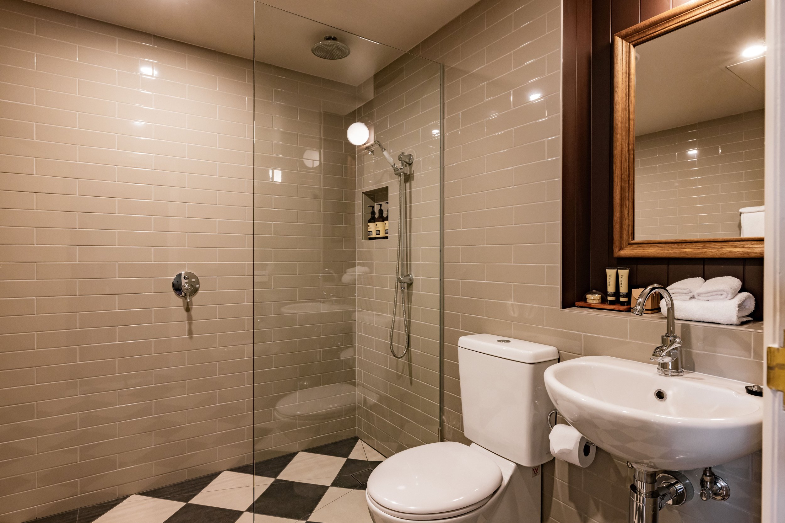Modern bathroom with rainwater shower head inside a suite at Hadley's