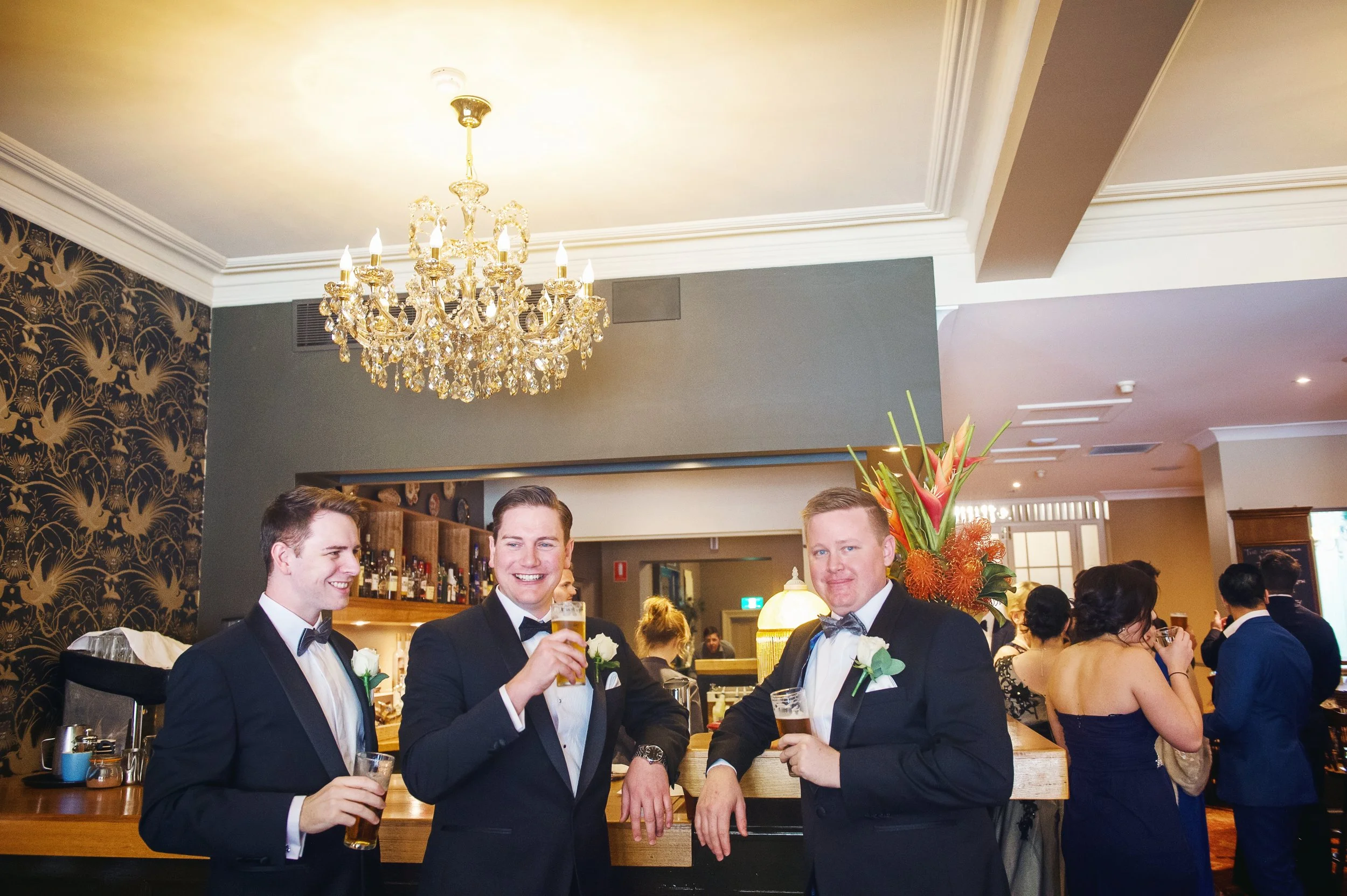 Groom and groomsmen enjoy a drink in the Orient Bar