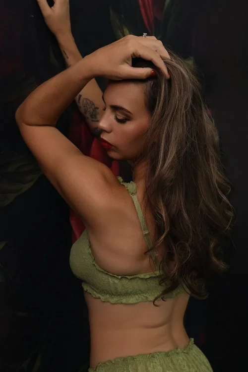 Editorial boudoir portrait with floral backdrop at Coffee and Boudoir in El Paso