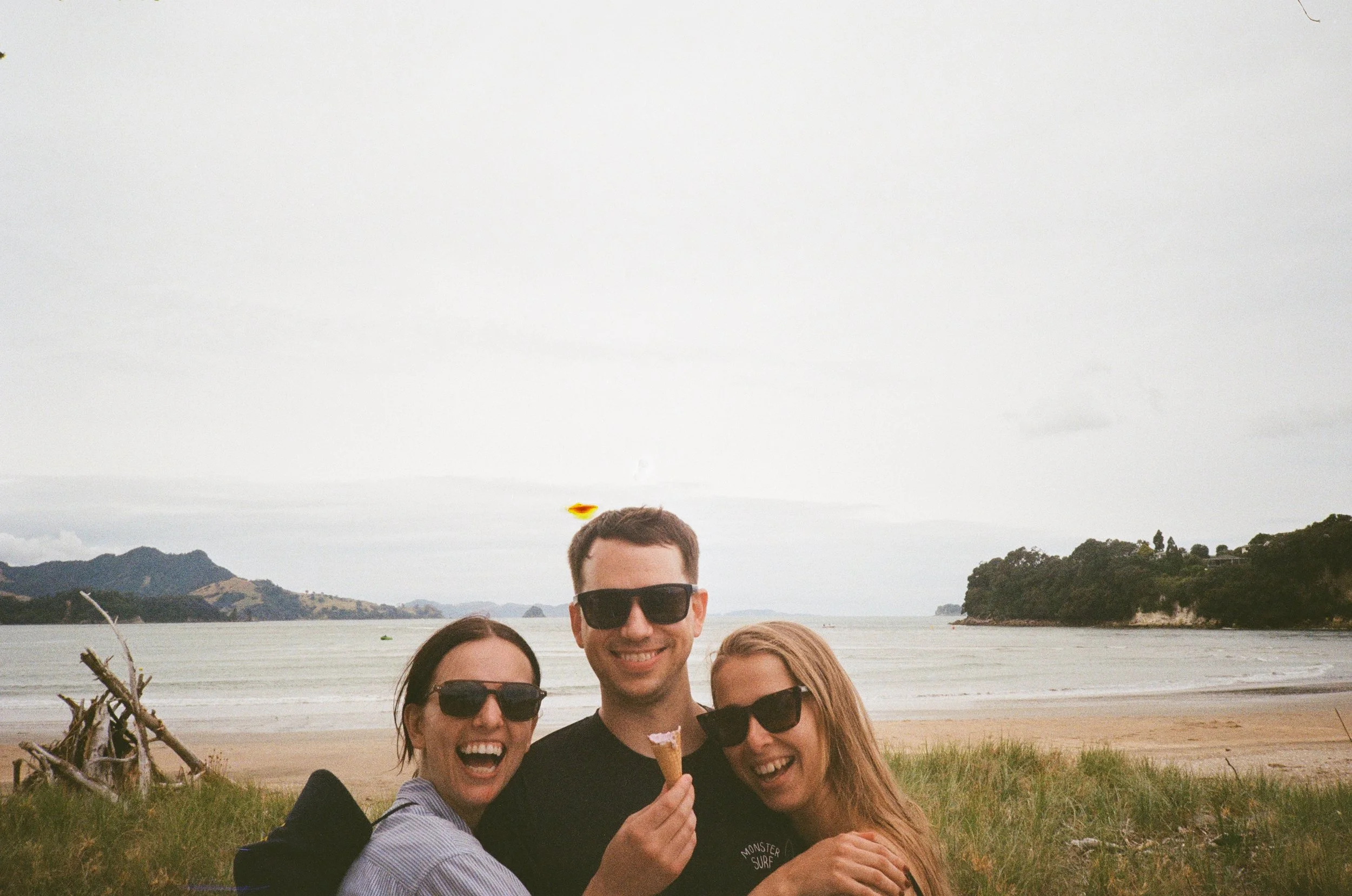 (Cooks Beach) - banana boat beach. Us sibling forcing Max into a hug.