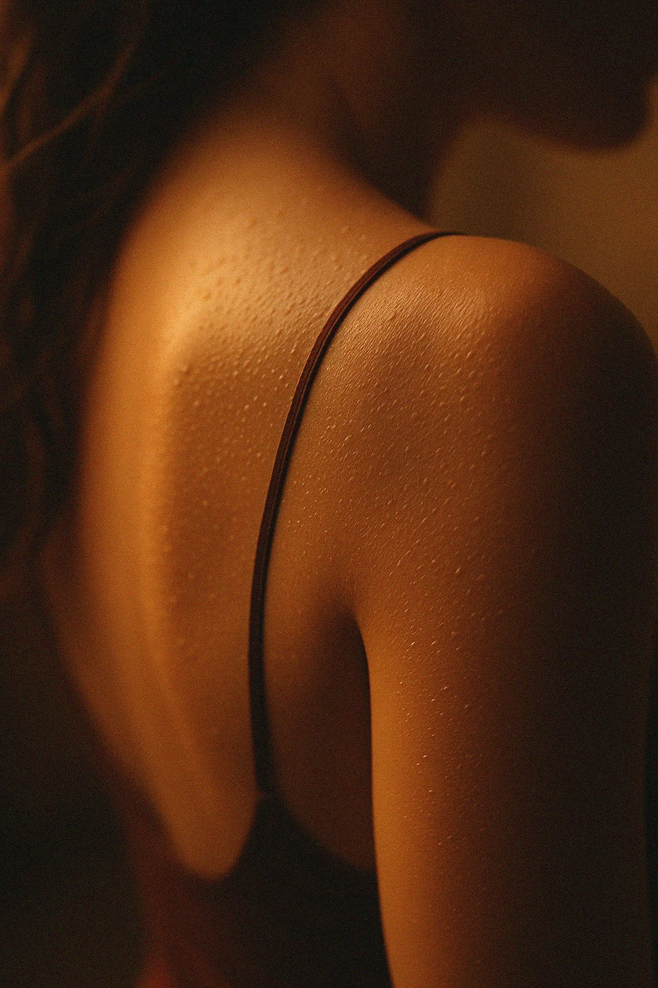 AI beauty editorial, shoulder detail in warm cinematic light