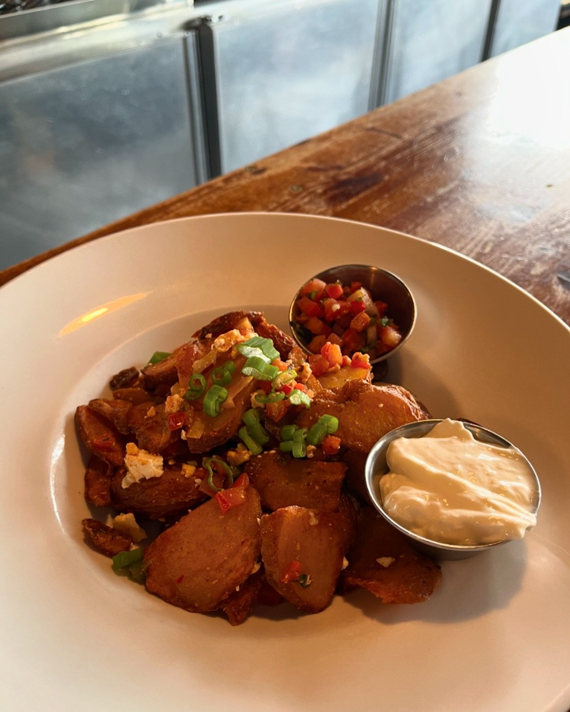 Dos Amigos Potato Appetizer 🌶️
&iexcl; new menu item alert ! 

Hand-cut potatoes tossed in chipotle, feta cheese, and topped with green onions &mdash; served with Tipper salsa and sour cream