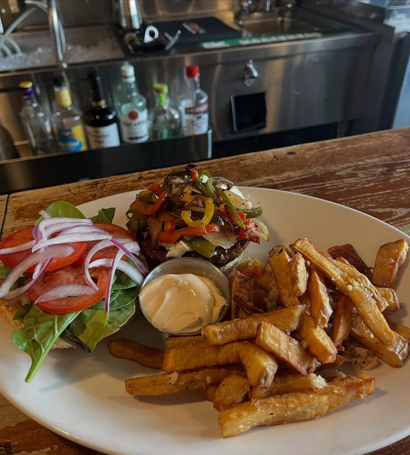 Here&rsquo;s a meal to write home about: in all its colourful glory, this is Tipper&rsquo;s Veggie burger with saut&eacute;ed peppers and onions added on top of the crumbly feta! This customer chose our garlic sweet potato fries for their side. Delis