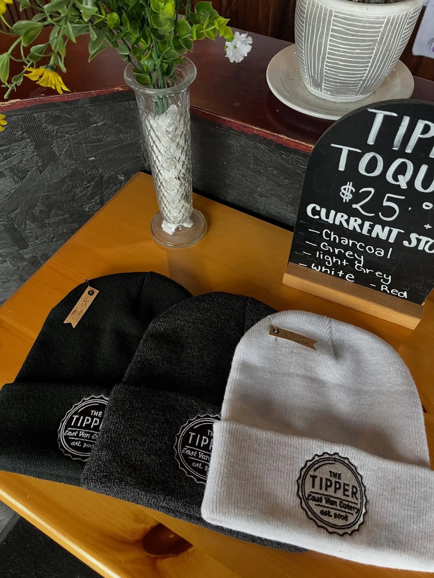 TIPPER TOQUES!! 
The perfect balance of warm without being itchy. Buy one for yourself or buy one for a loved one this holiday season! On sale for $25 + tax. 

That&rsquo;s not all! We sell t-shirts in both male and female sizing, as well as wonderfu