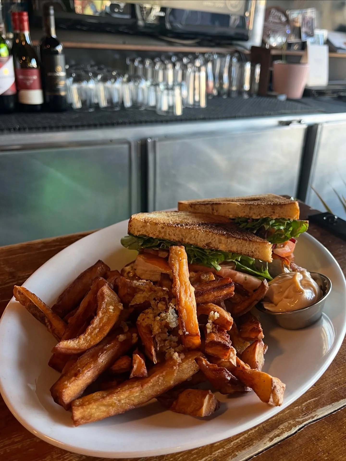 Sourdough Grilled Chicken Club Sandwich 🥪 featuring Tipper&rsquo;s special hand-cut twice-fried sweet potato fried tossed in fresh garlic and served with house-made chipotle mayo. 

Pro tip: Dip the fry into the mayo and then back into the garlic (t