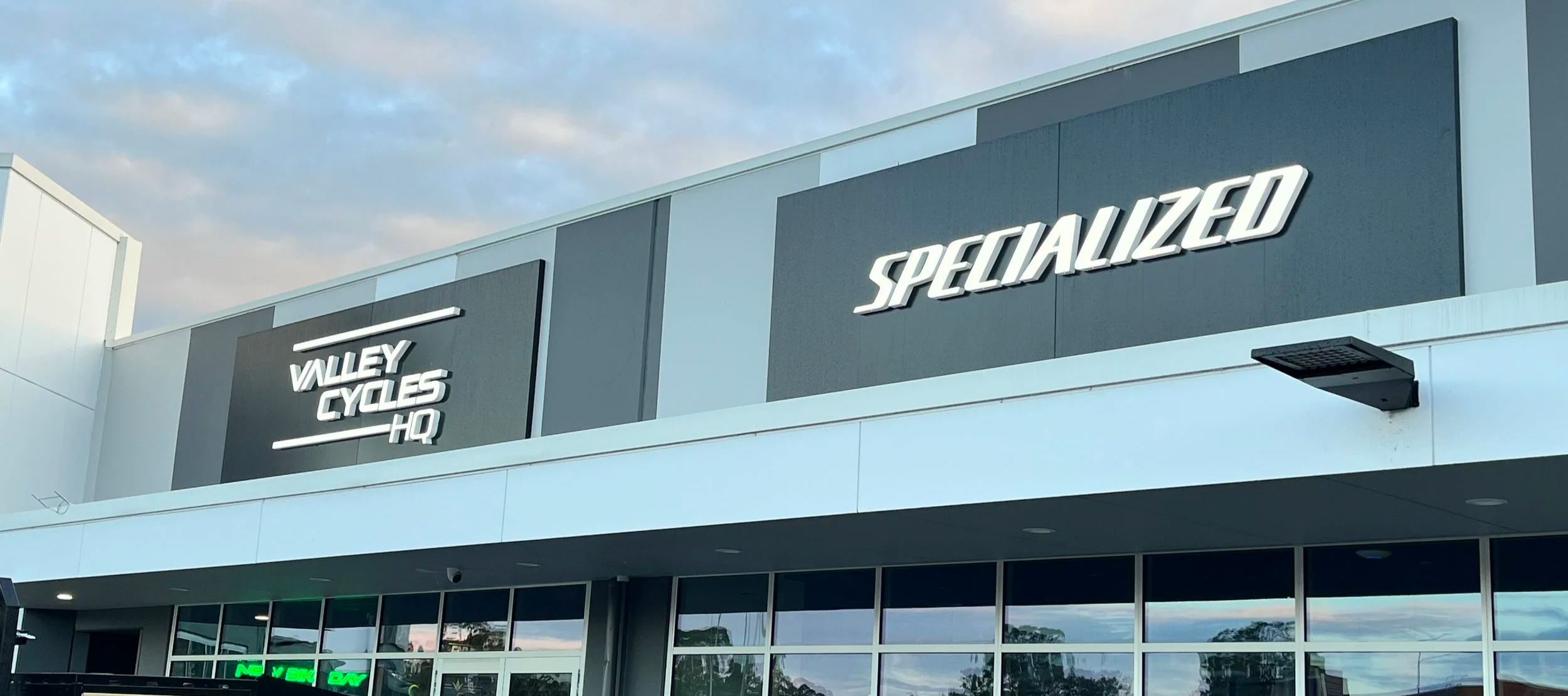 Raised white Valley Cycles HQ and Specialized lettering on a commercial building façade.