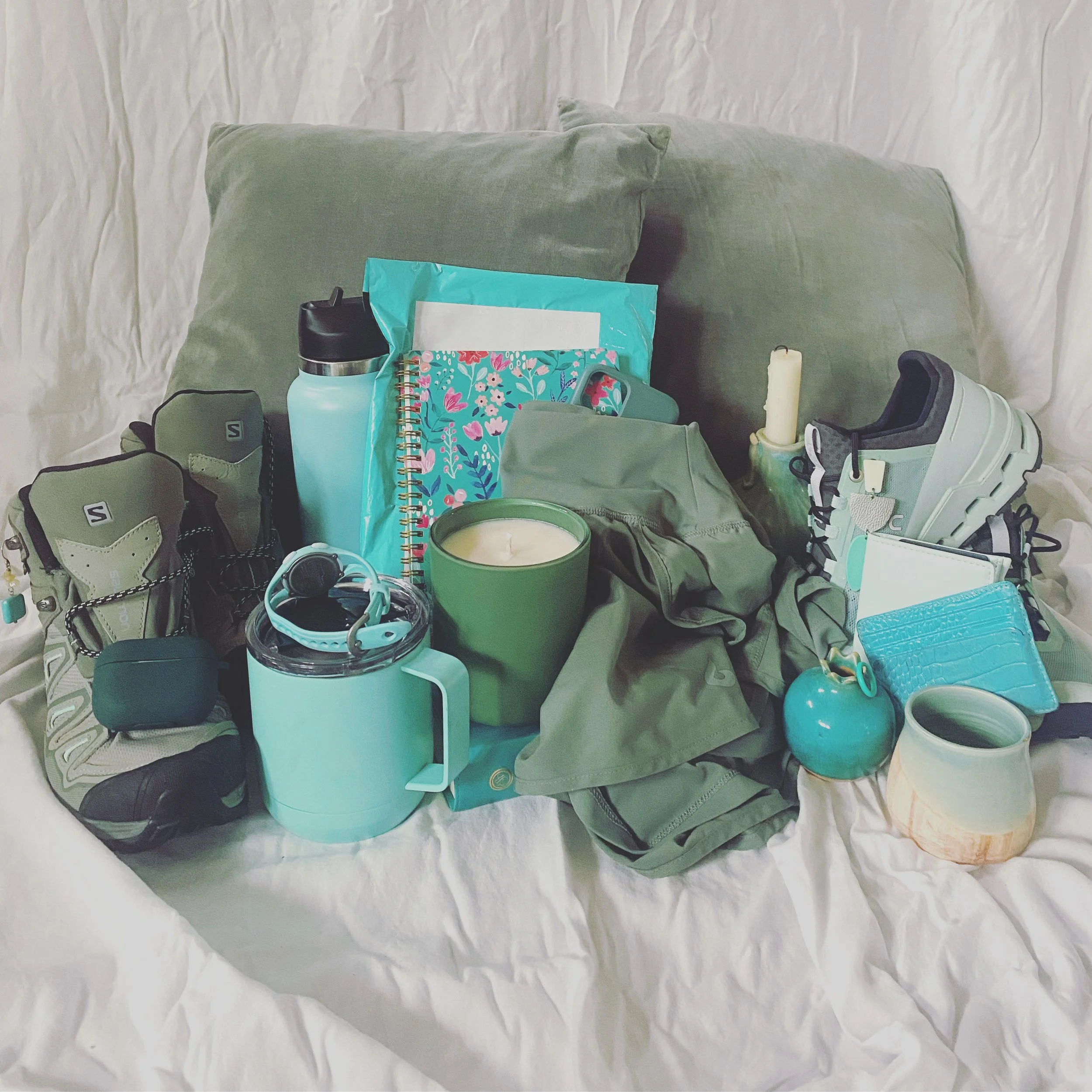 Collage of teal colored items - running shoes, candle, water bottle, running shorts, and more.