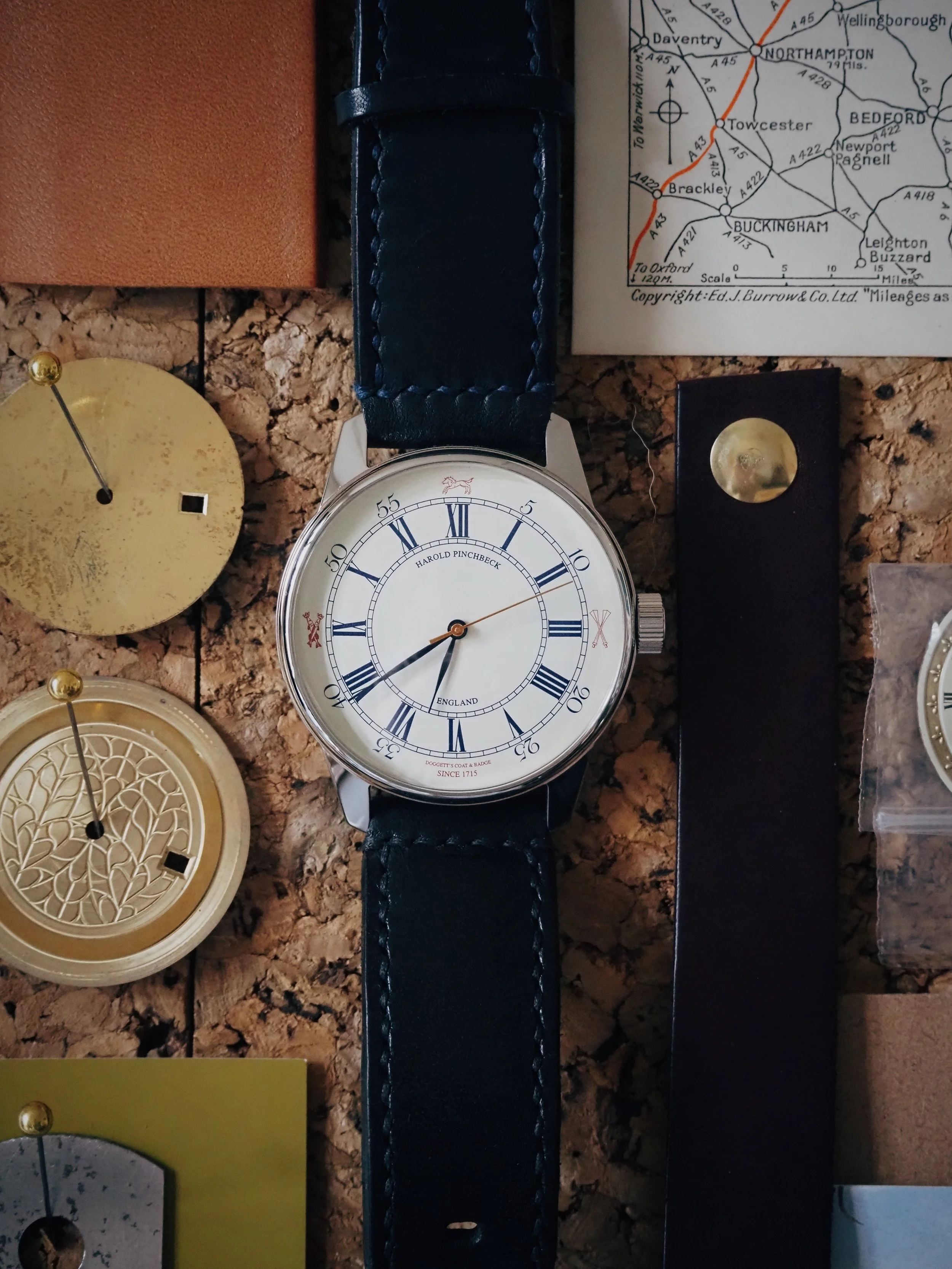 Luxury analog watch with brown leather strap and Roman numeral dial