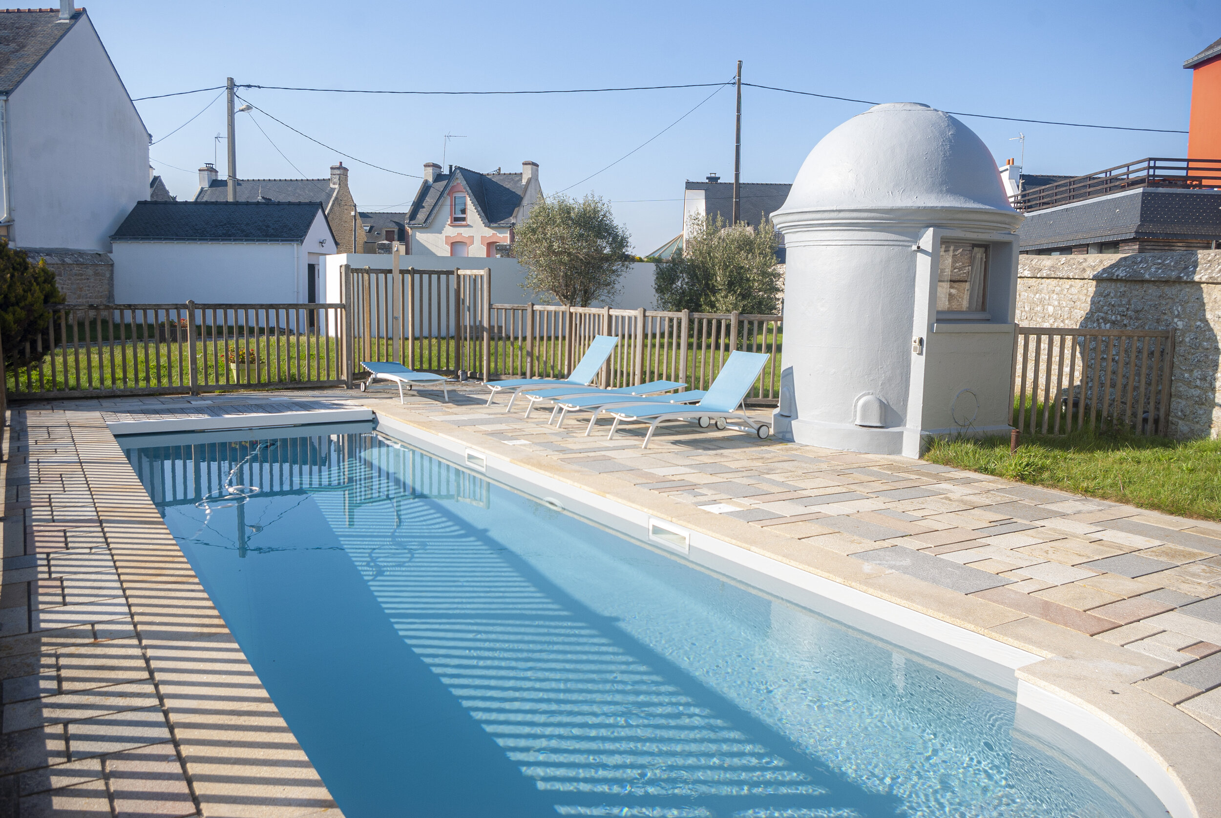 The swimming pool, its deckchairs, the sauna