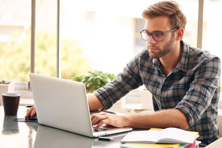 Professional receiving one-on-one Microsoft Project coaching while working on a laptop.
