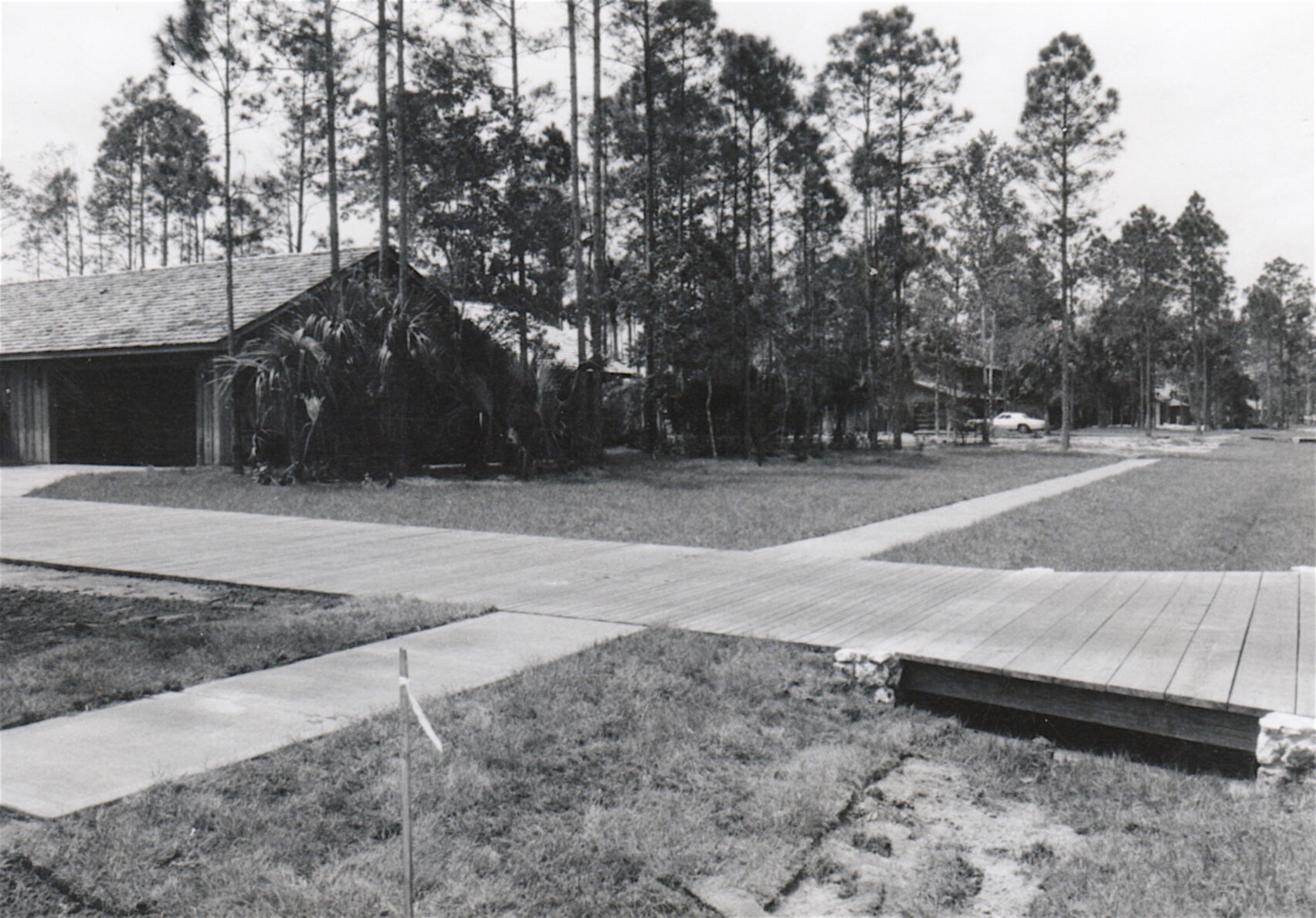 1980 home with wooden driveway along Pelican Bay Dr.