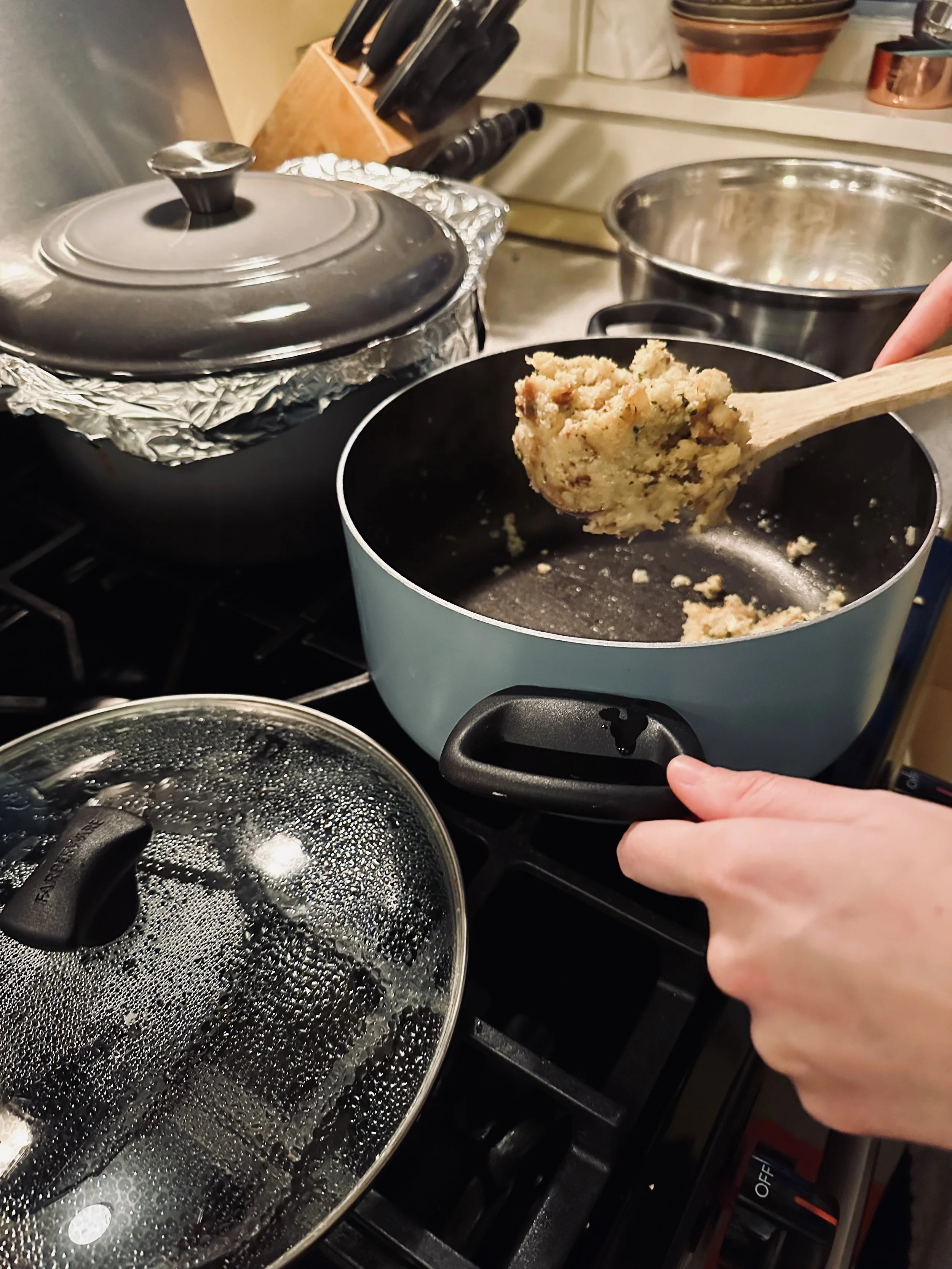 stuffing being cooked and scooped onto a wooden spoon
