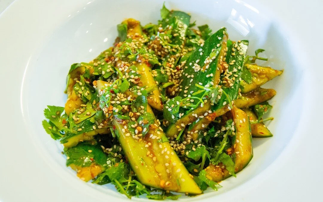 we have been making a version of this Smashed Cucumber Salad for months - but this version is dialed in.  Using English Cucumbers, Fresh Cilantro, Homemade Chili Oil, Tahini, and Black Rice Vinegar we created a vibrant and incredibly light dish that 