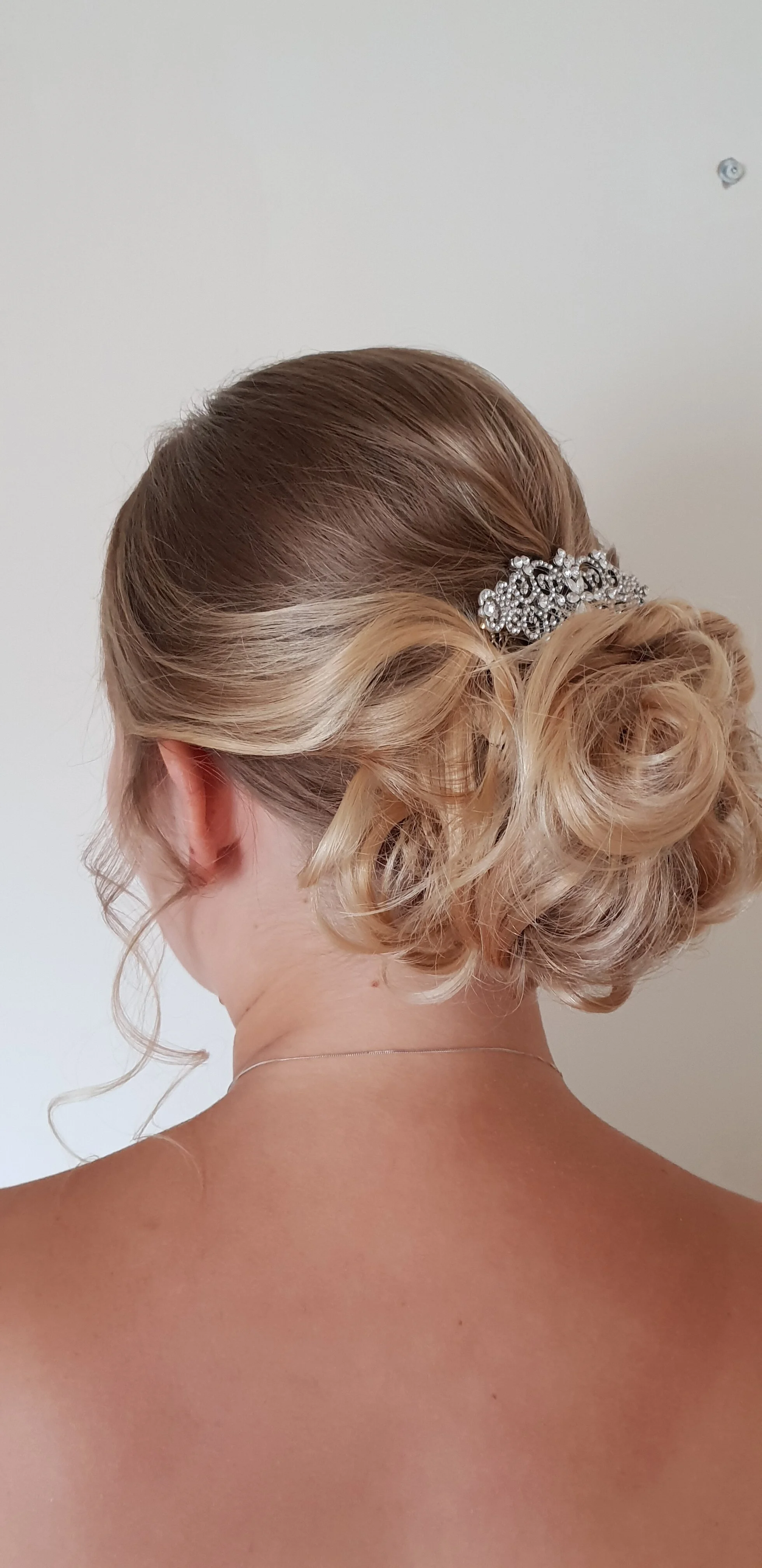 loose curl central bun bride