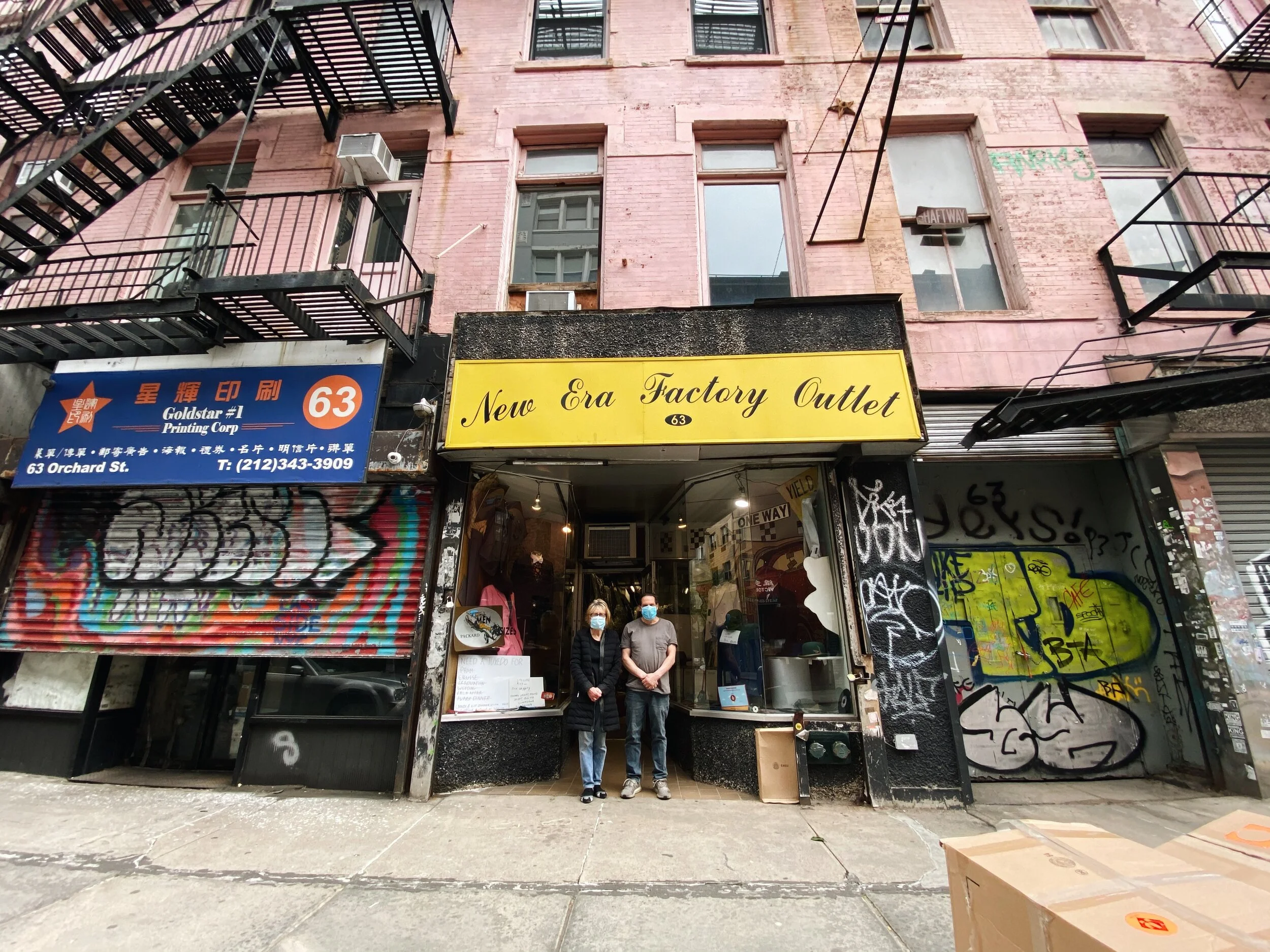 New Era Factory Outlet owners Robert and Vivian Zaiger outside of the suit shop at 63 Orchard Street during the coronavirus pandemic. Photo by Alexandria Misch for Canal Street News