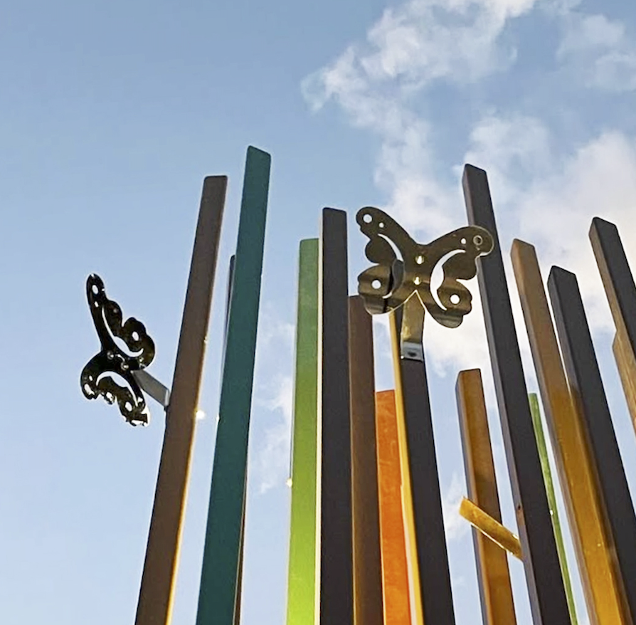 Polished stainless steel reflectors designed in a light casting butterfly shape (painted reed grasses by Walker Design)