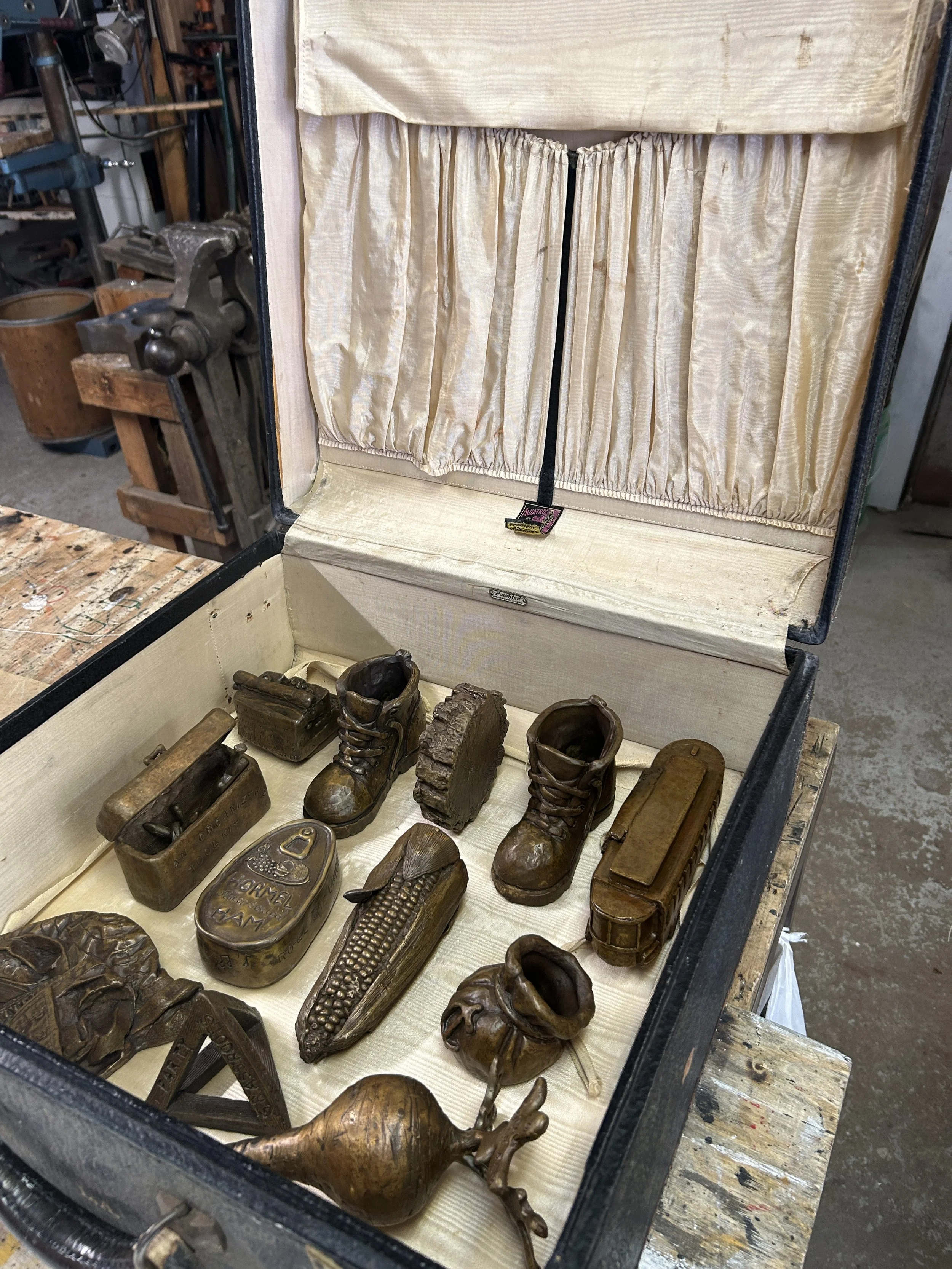the suitcase, eventually made with a wooden grid to hold the pieces for traveling