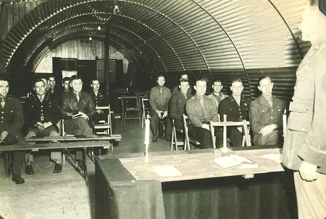 Chaplain Reid delivering his homily in quonset hut congregation