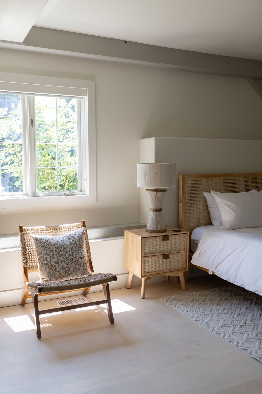 King bedroom with white linens and wood furniture located on the ground floor of The Ayrshire Laigh