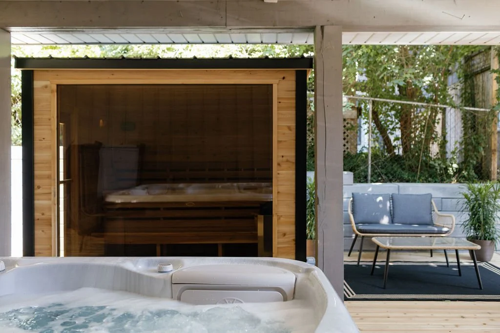 Traditional cedar sauna, Hydropool hottub, and an outdoor patio area