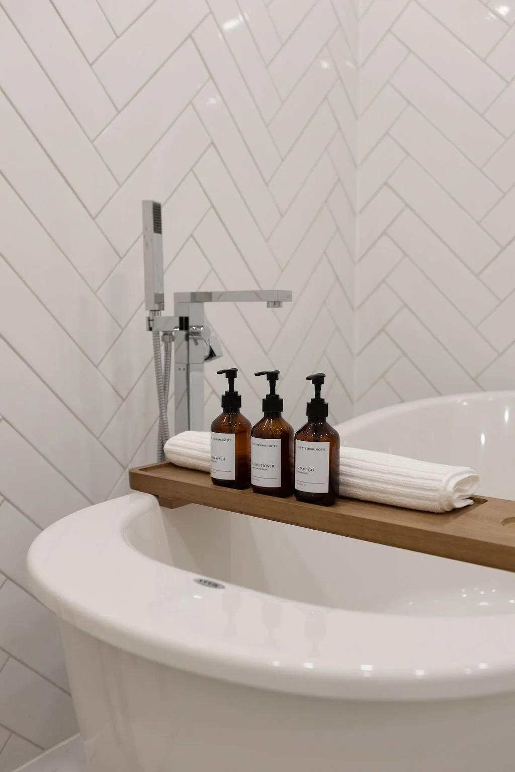 large soaker bathtub with luxury products for guest use