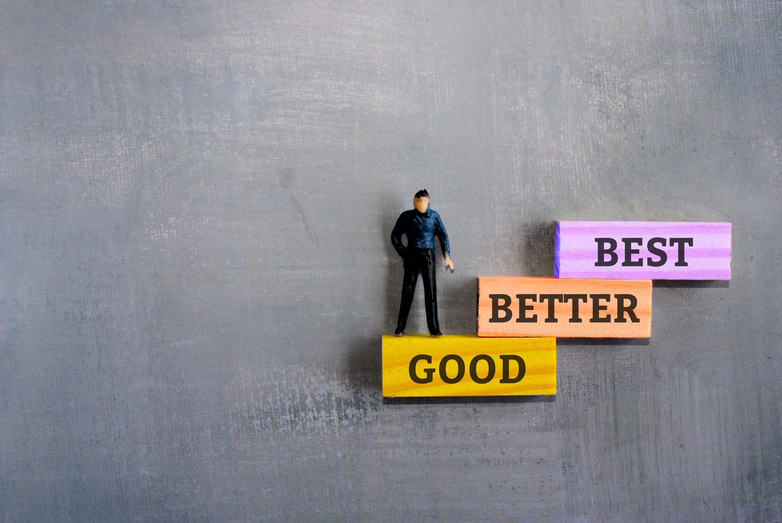 man representing search engine marketing agency climbing good better best blocks